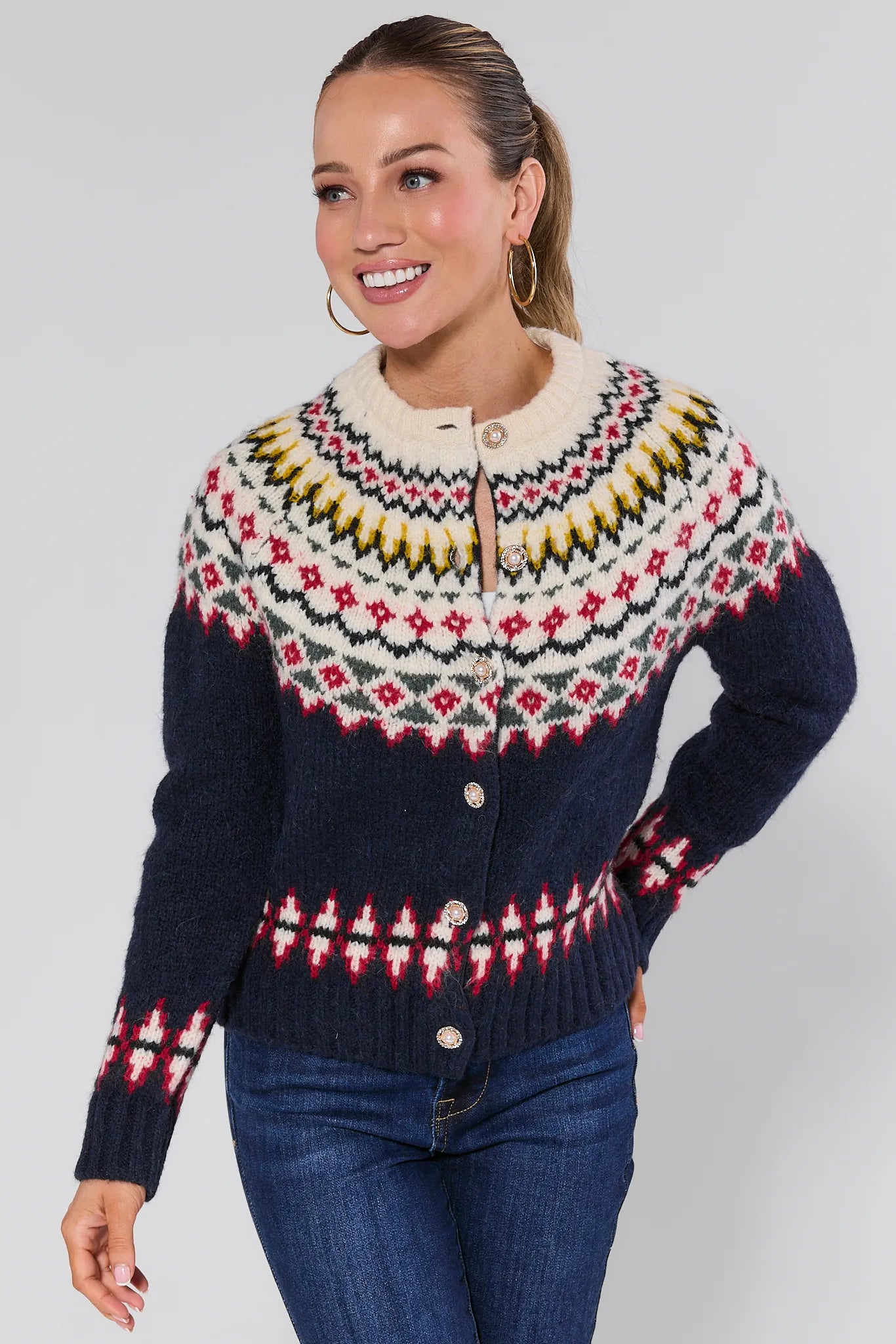 Woman wearing a Aspen Fair Isle Knit Cardigan with a plain background