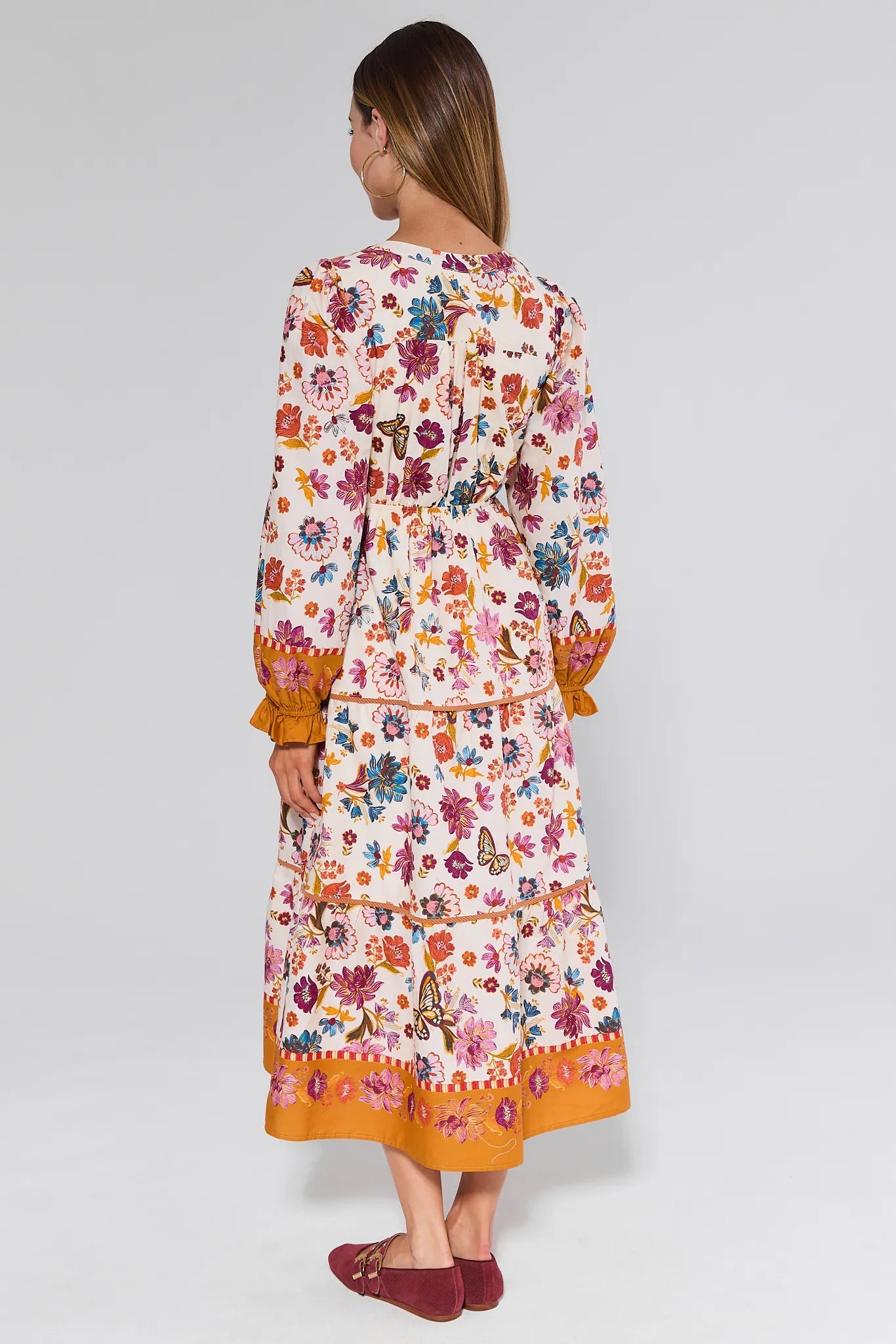 Woman wearing a floral Shiloh Dress with a white background