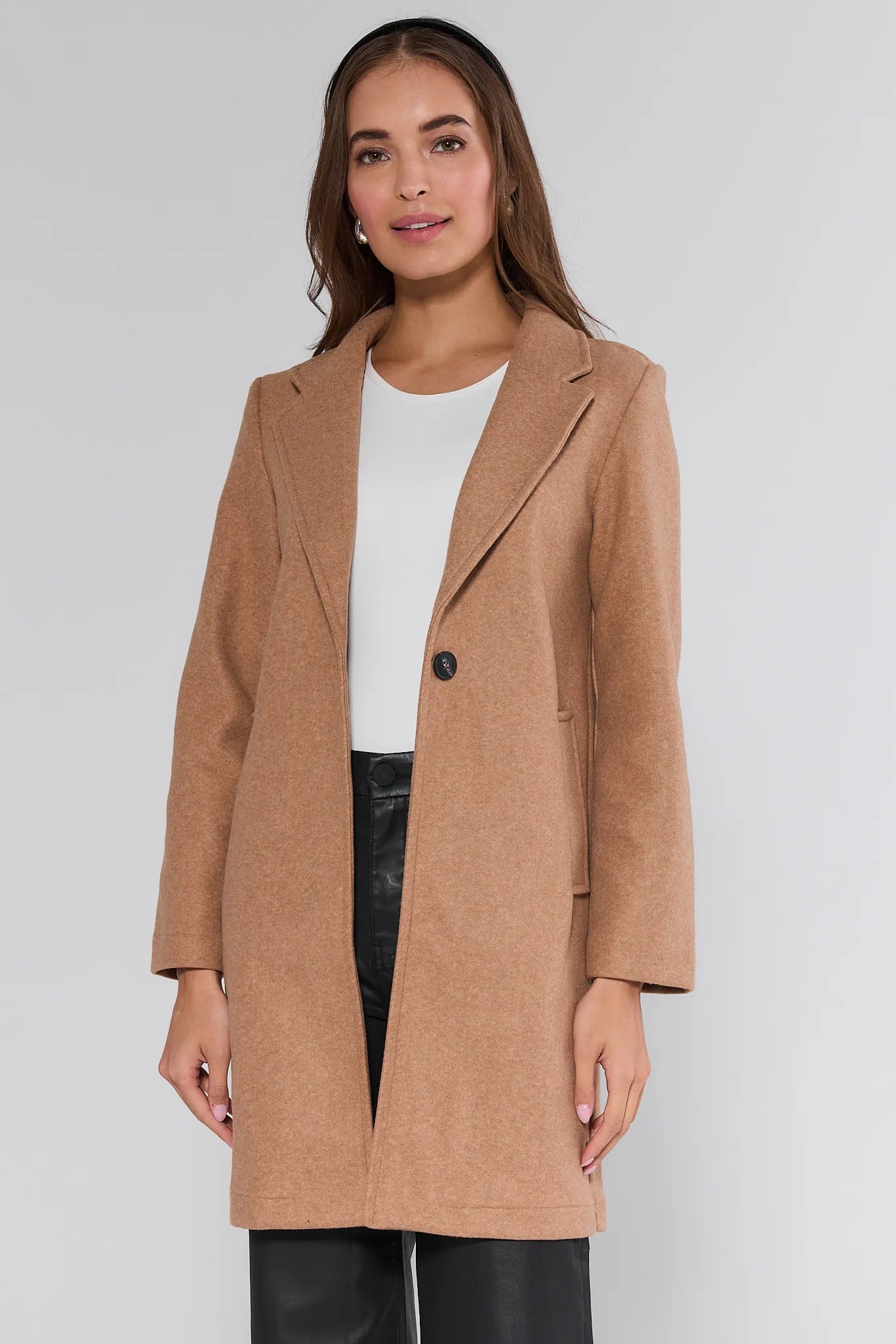 Woman wearing a brown Lauren Coat
on a plain background