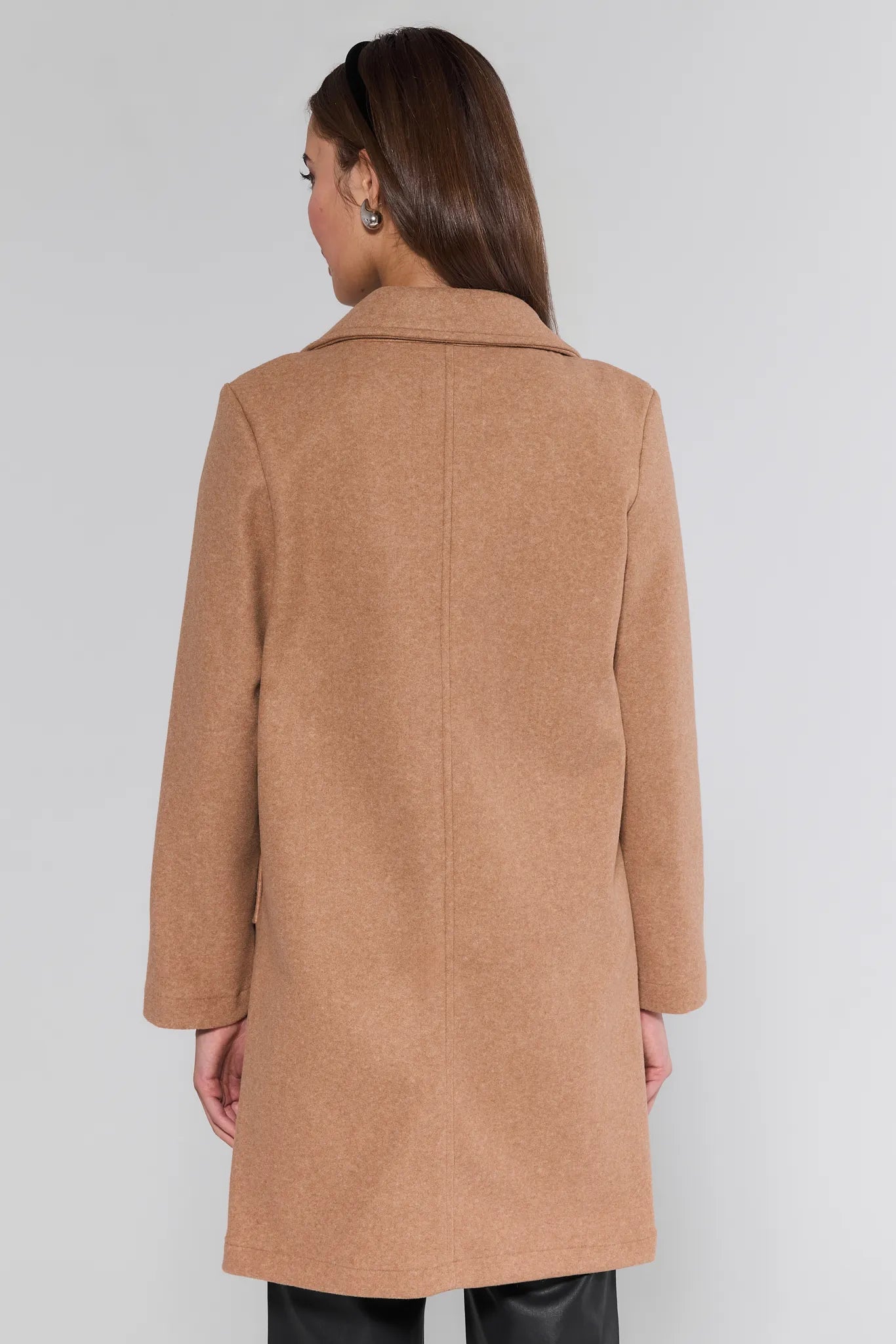 Woman wearing a brown Lauren Coat on a white background