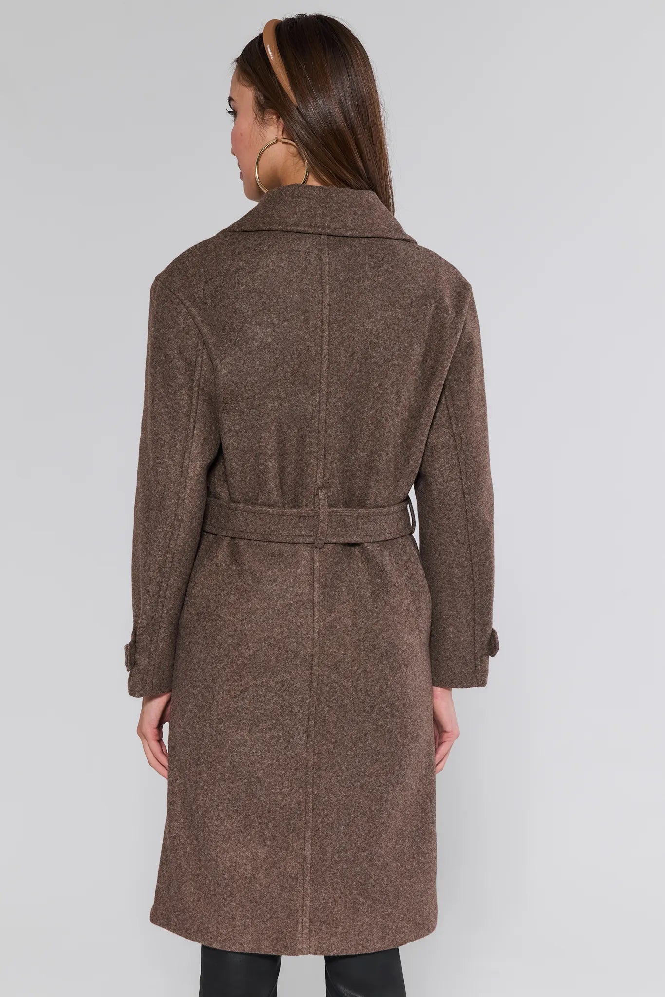 Woman wearing a brown Sadie Coat on a white background