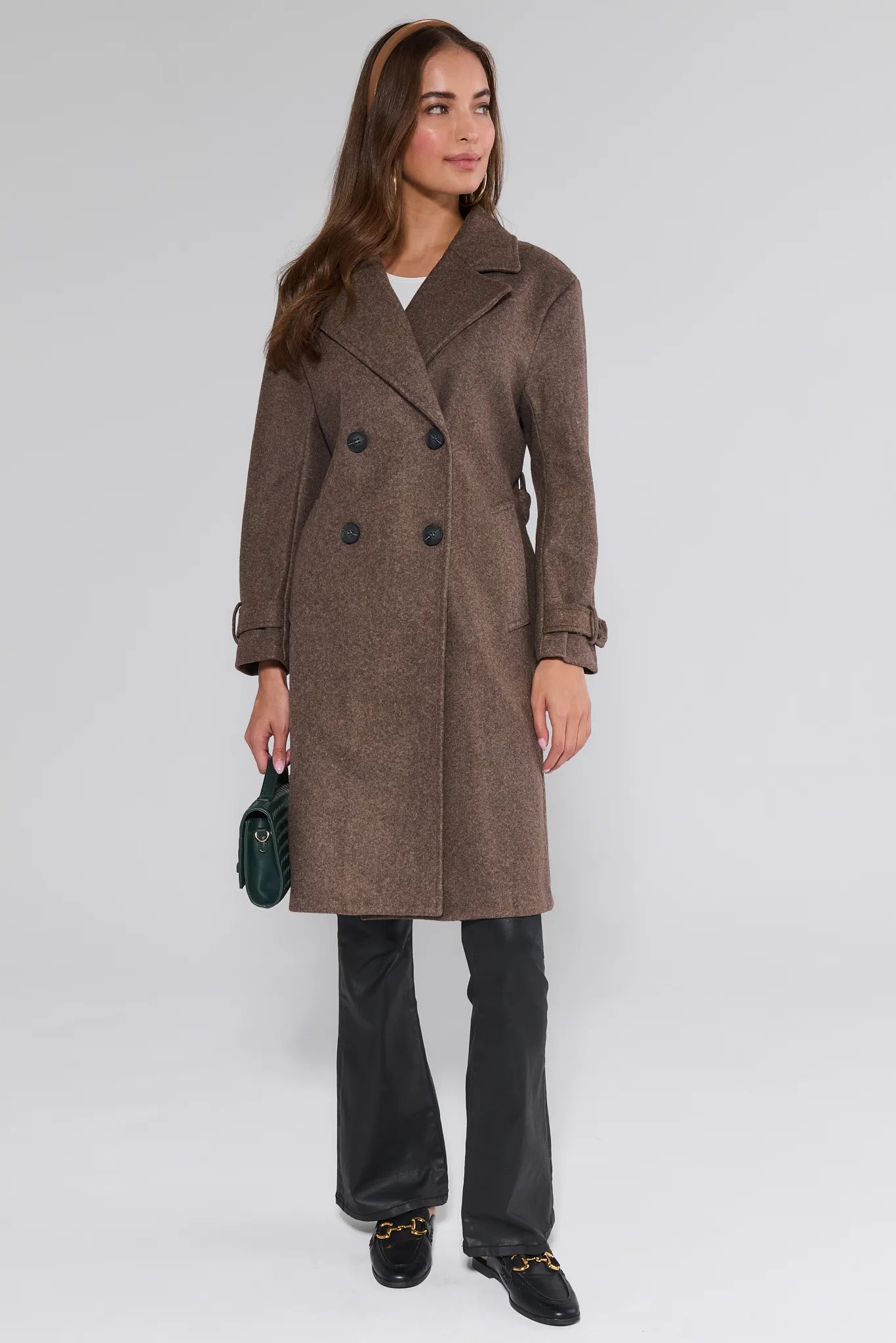 Woman wearing a brown Sadie Coat on a white background