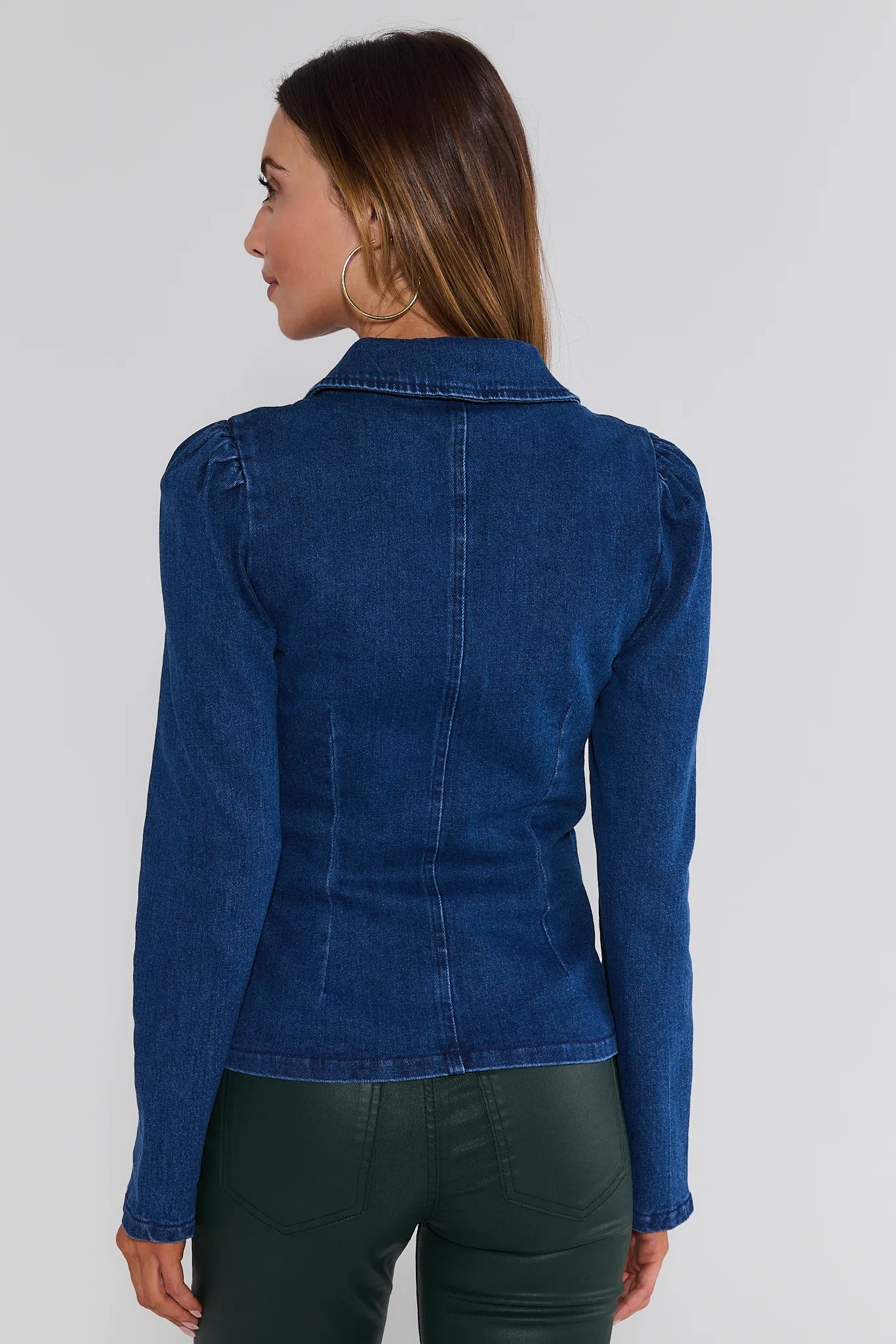 Woman wearing a blue denim Nellie Top on a white background