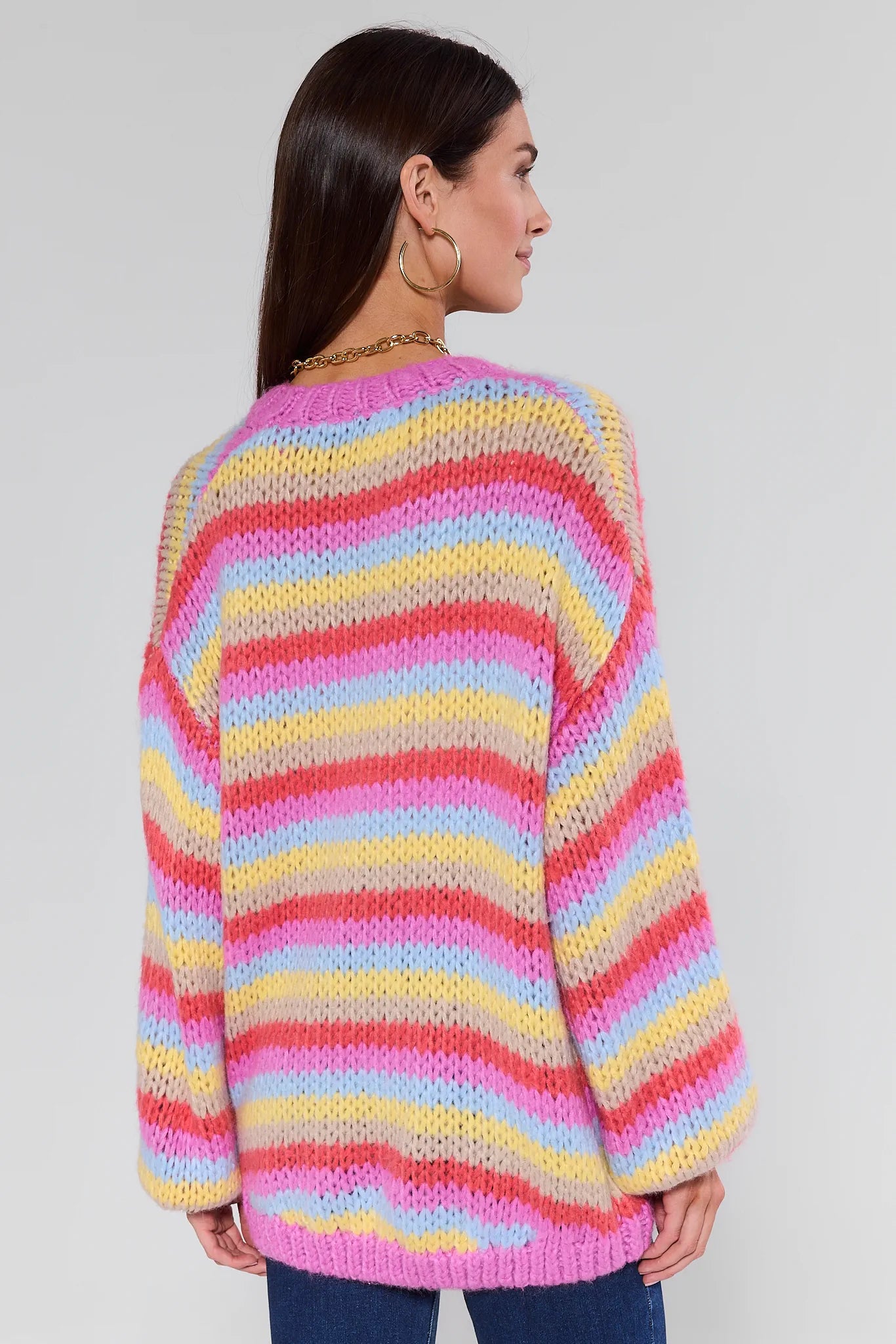 Woman wearing a Adrienne Multi Striped Knit Cardigan on a plain background