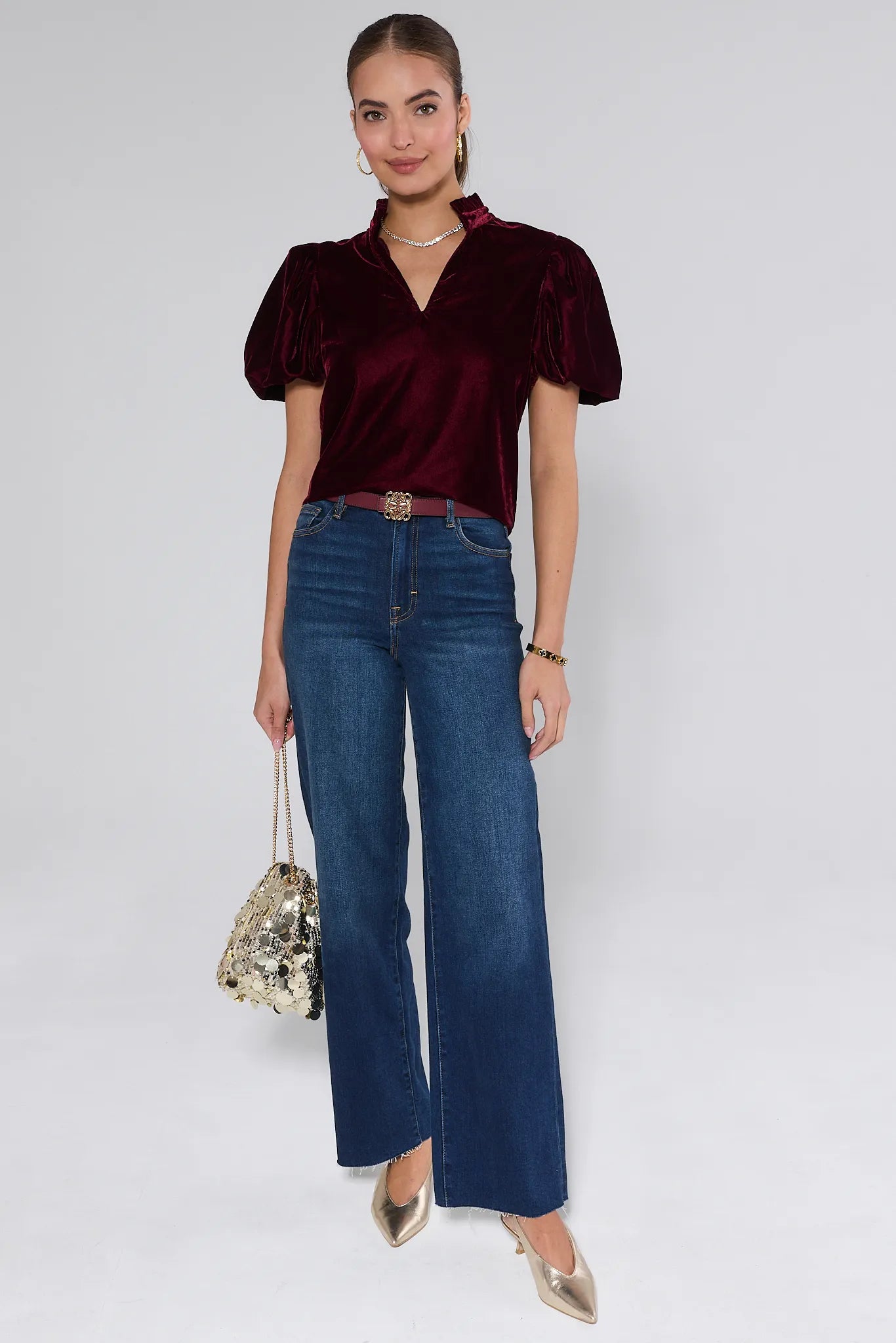 Woman wearing a Lynette Cranberry Velvet Puff Sleeve Top against a plain background