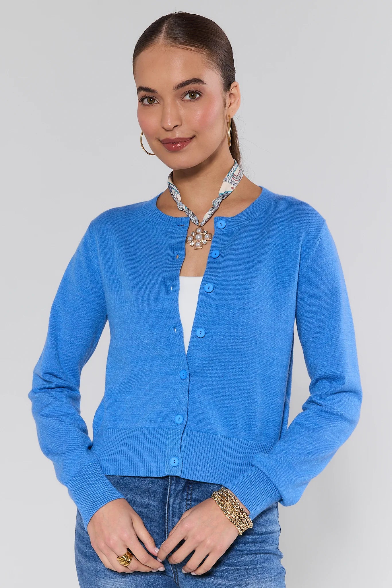 Woman wearing a Sarah Blue Button Up Cardigan on a plain background