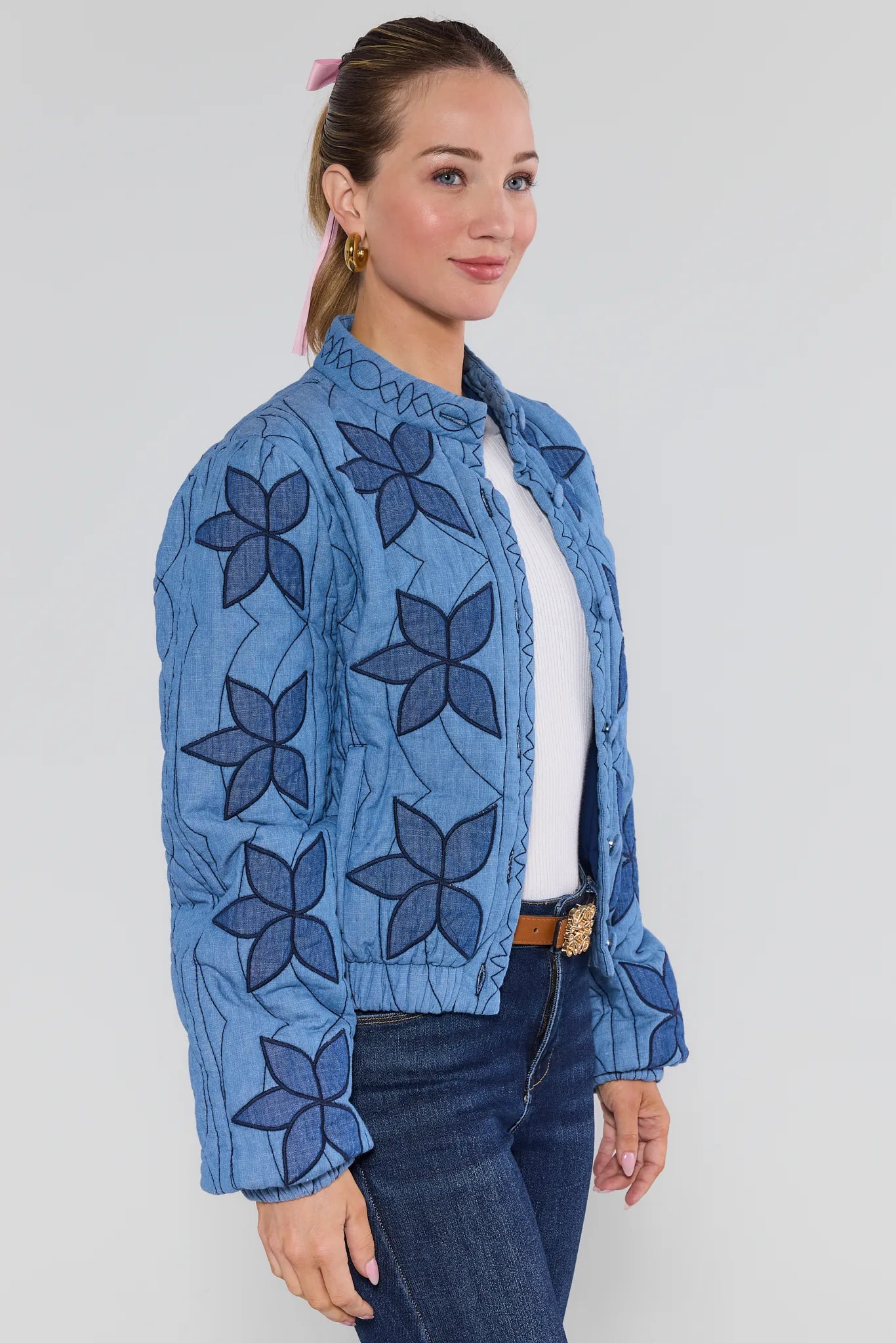 Woman wearing a blue floral-patterned Krista Jacket on a white background