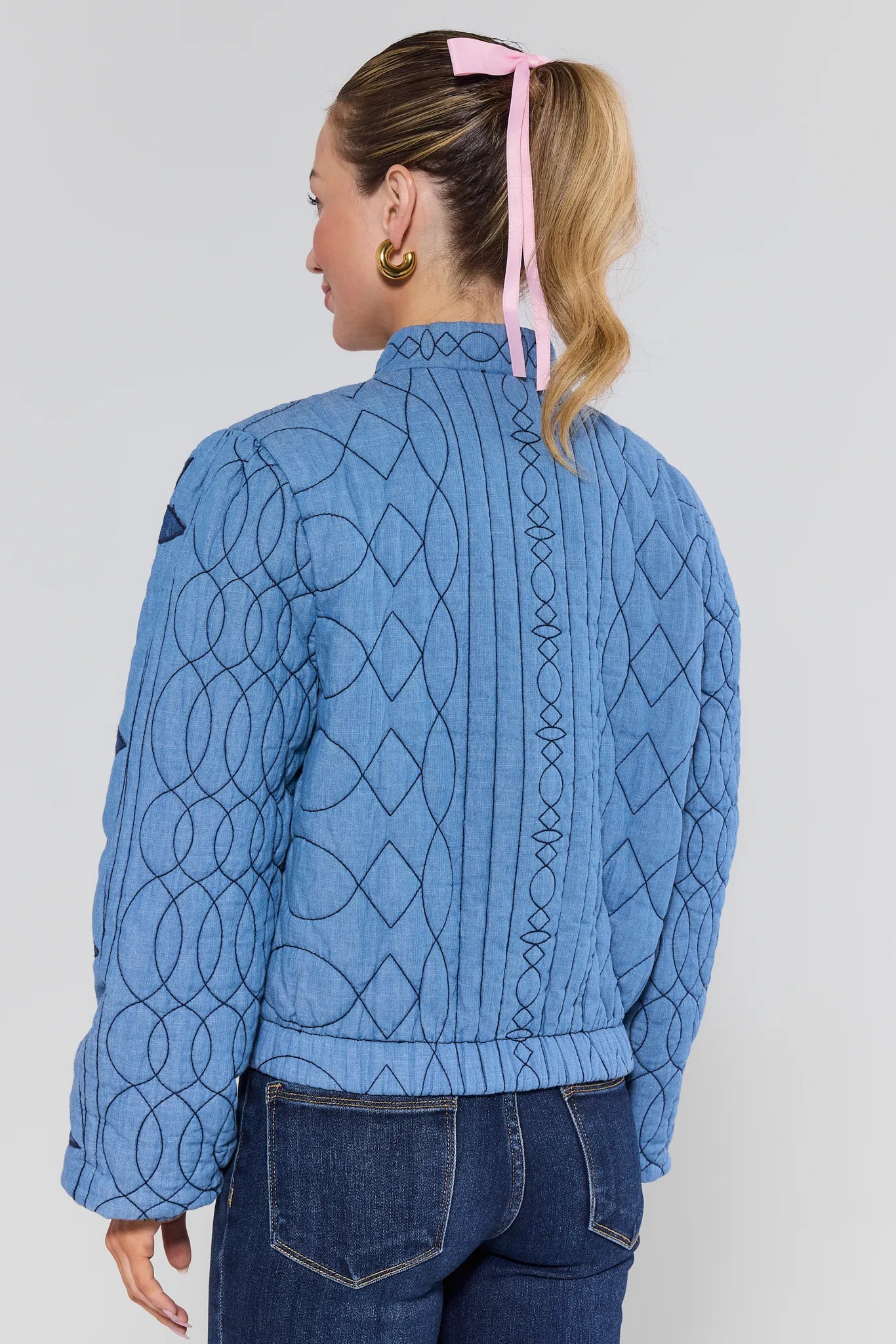 Woman wearing a blue patterned Krista Jacket with a white background