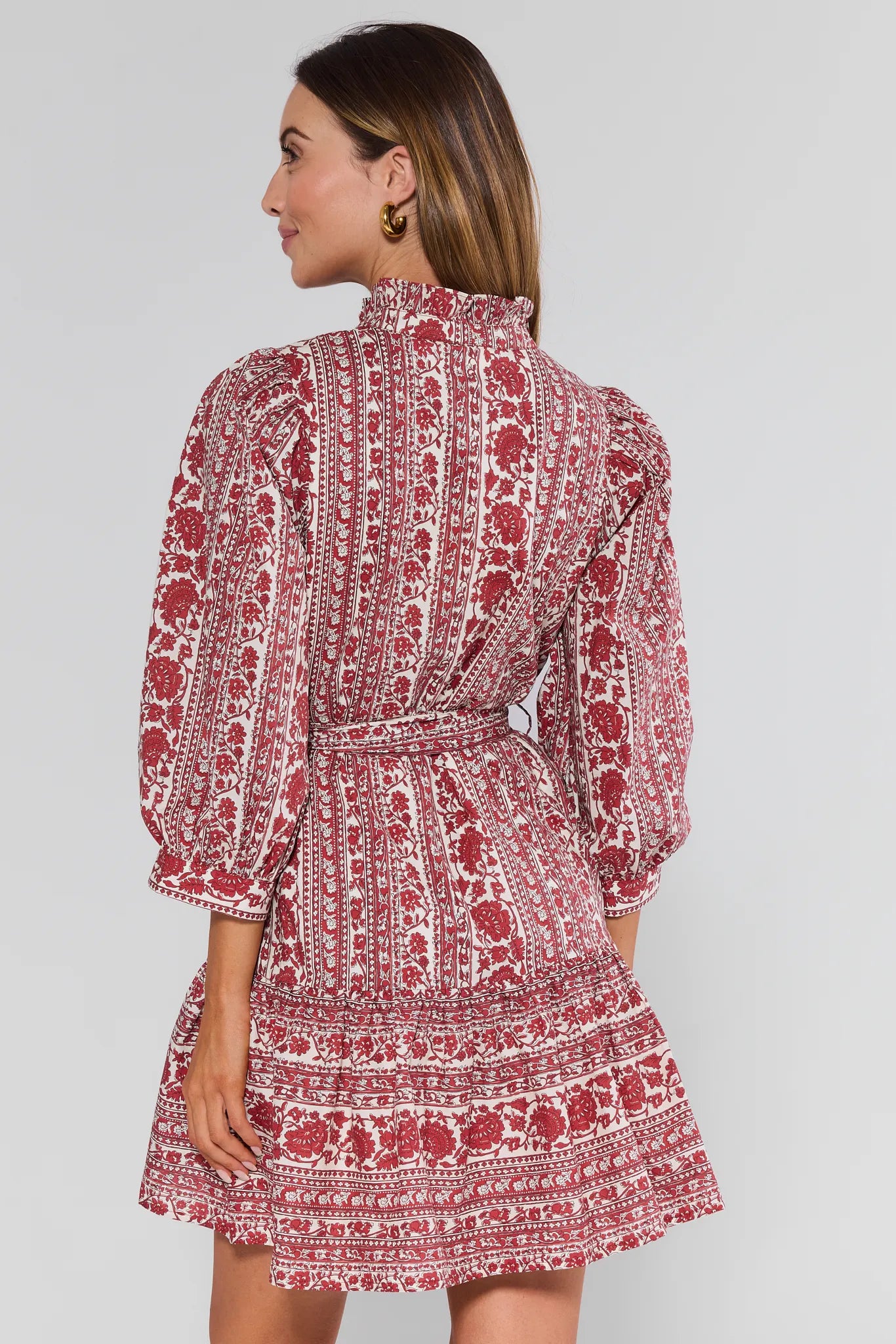 Woman wearing a red and white patterned Morgan Dress on a plain background