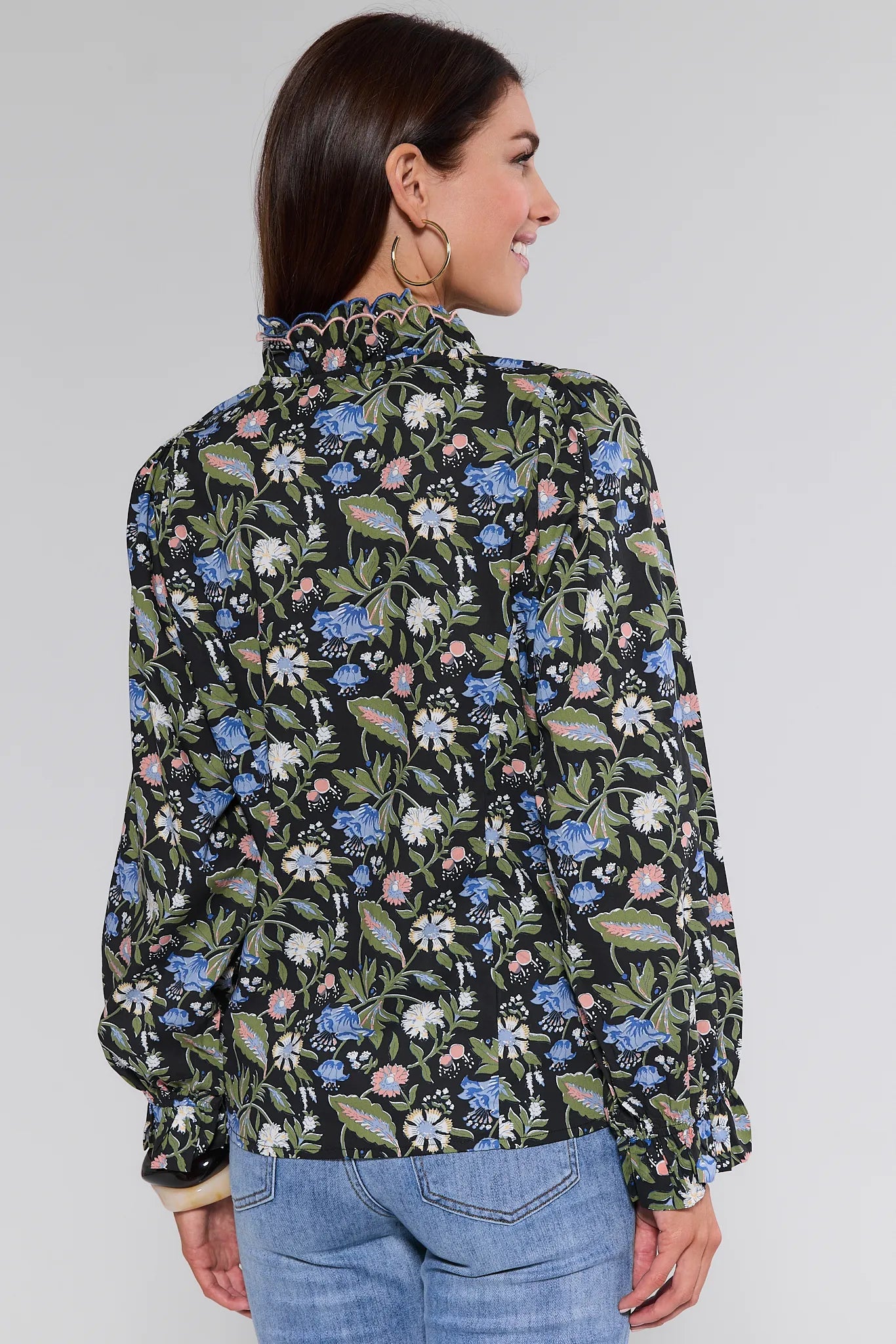 Woman wearing a floral patterned Florence Top against a plain background