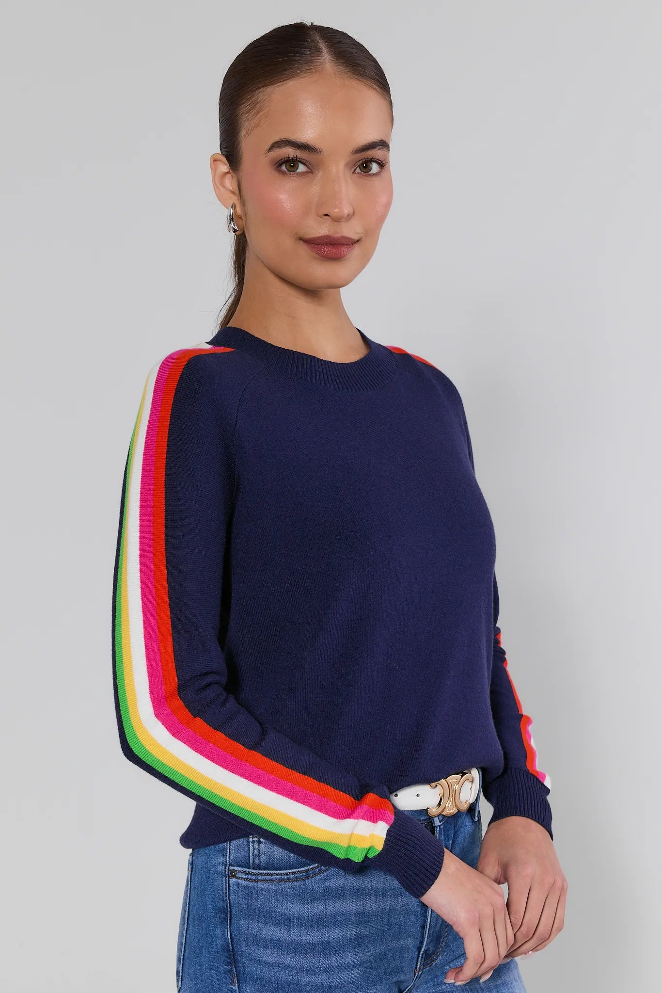 Woman wearing a navy sweater with colorful stripes on a plain background Khloe Navy Striped Sleeve Sweater