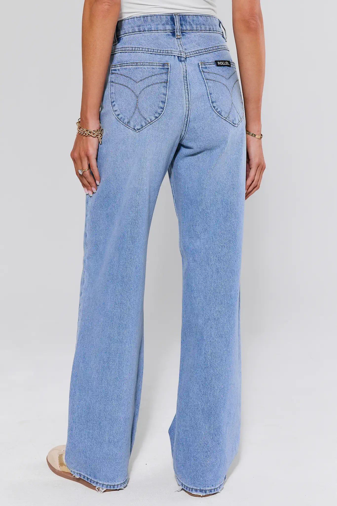 Light blue jeans worn by a person on a white background