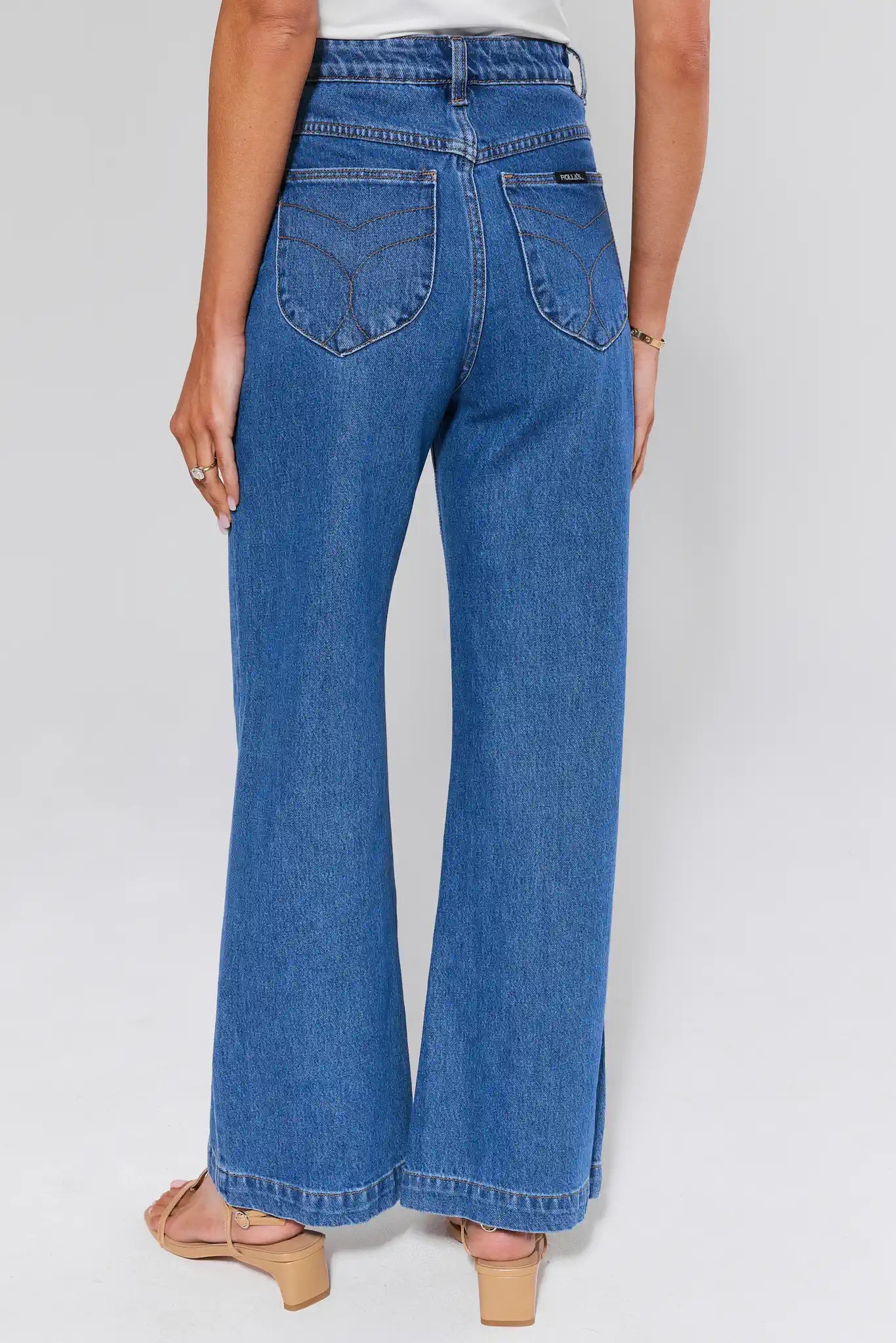 Blue jeans worn by a person on a white background