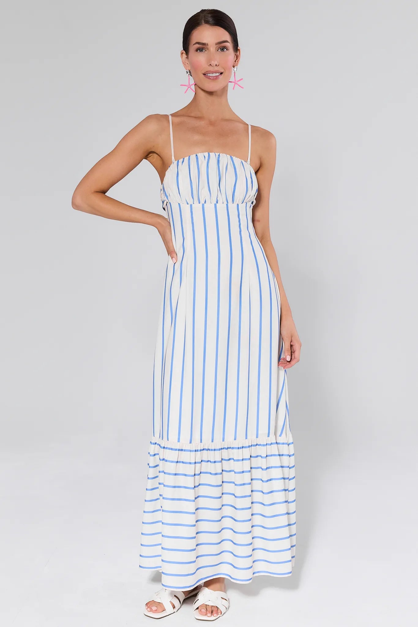 Woman wearing a Finley Striped Maxi Dress on a gray background