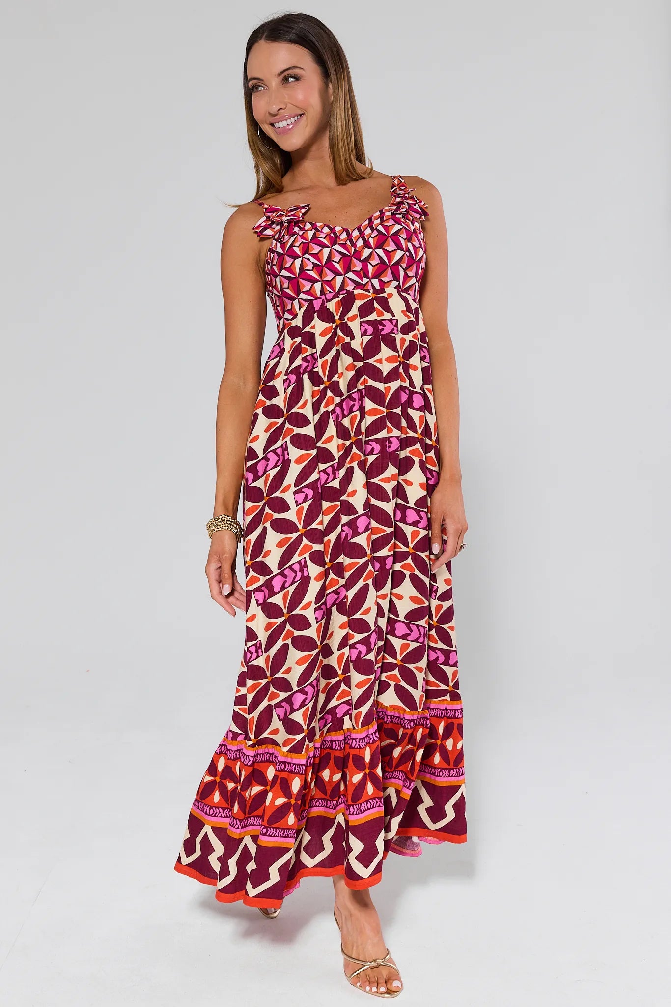 Woman wearing a Jackie Pink Printed Midi Dress on a plain background