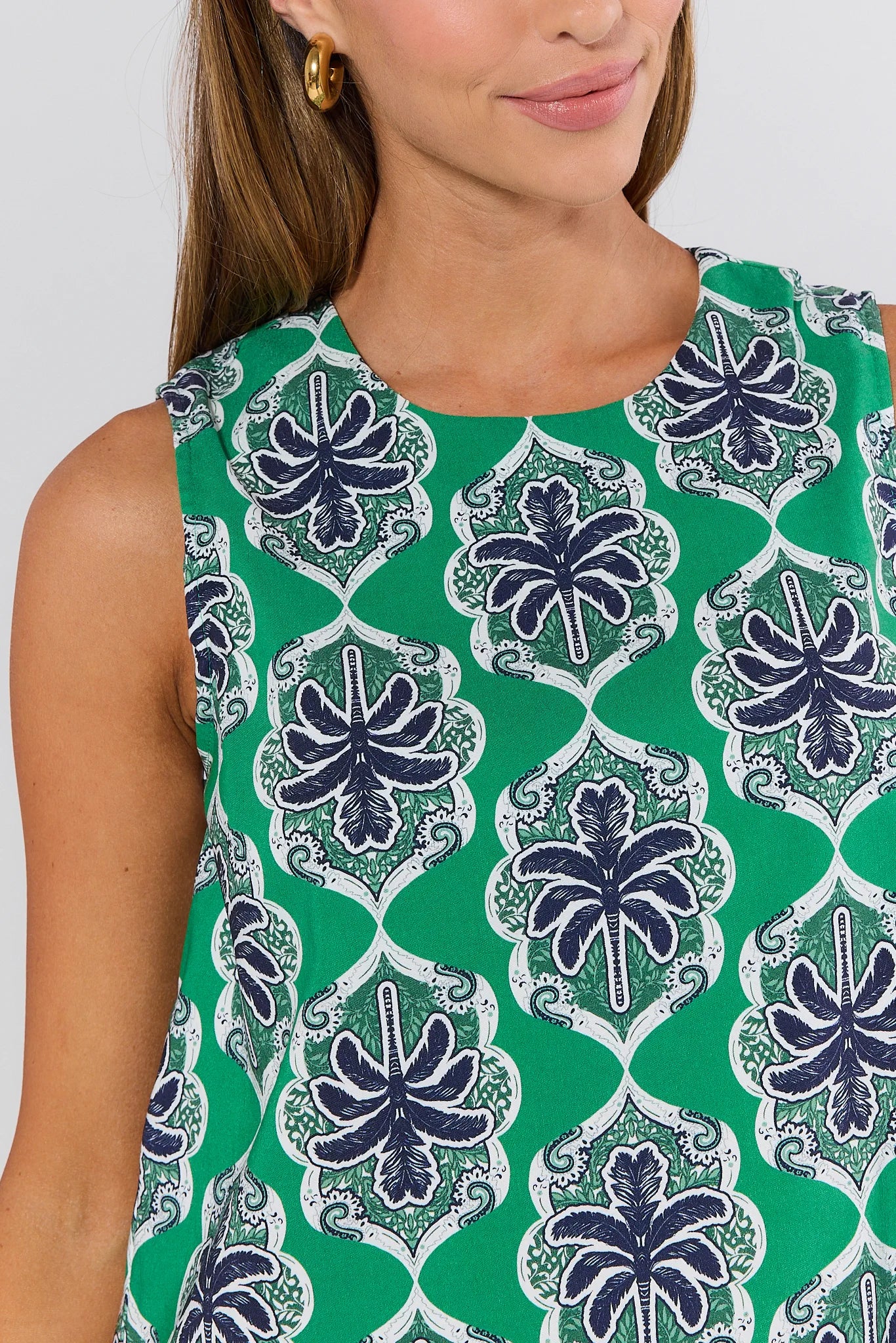 Woman wearing a green and blue patterned sleeveless top against a white background Goldie Green Printed Tank Top