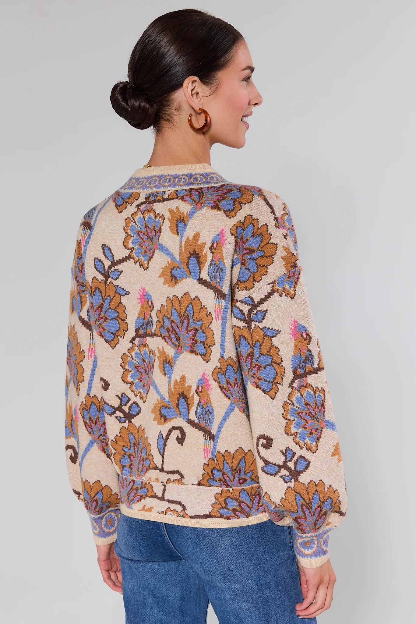 Woman wearing a Mavis Floral Knit Cardigan with a plain background