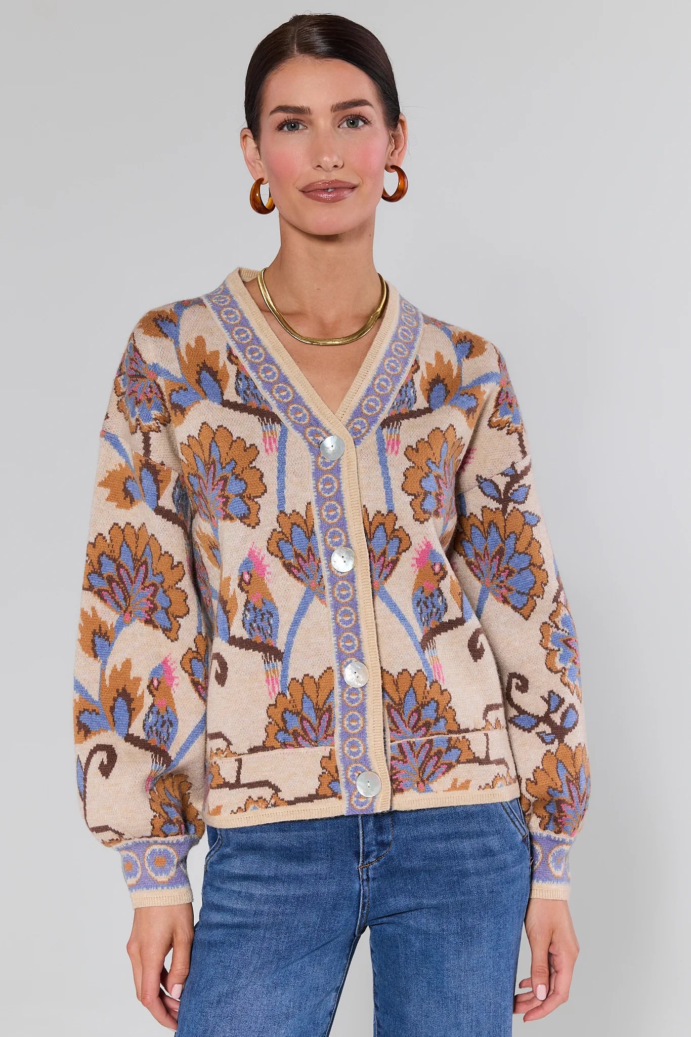 Woman wearing a Mavis Floral Knit Cardigan with a plain background