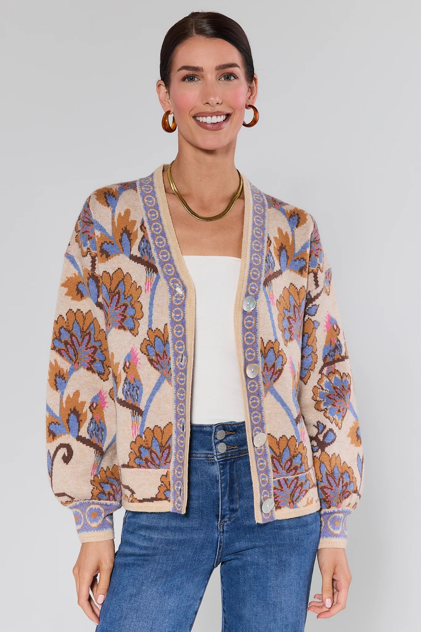 Woman wearing a Mavis Floral Knit Cardigan with a plain background