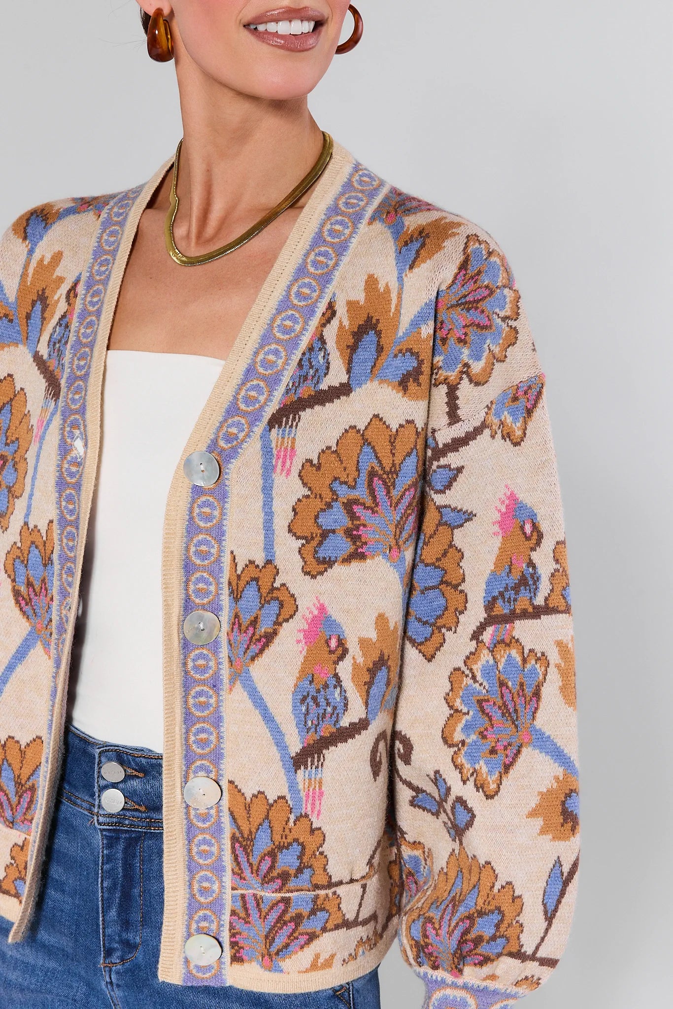 Woman wearing a Mavis Floral Knit Cardigan with a plain background