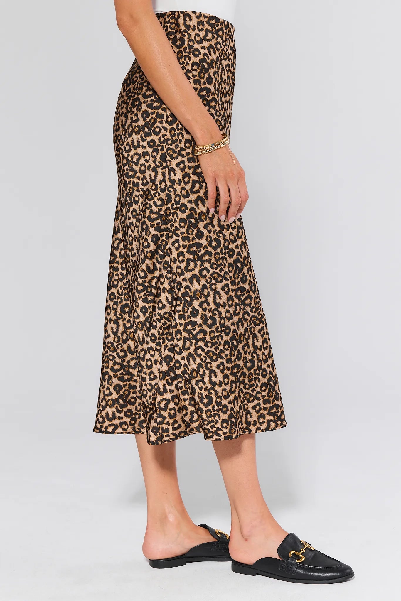 Person wearing a leopard print Gretchen Skirt on a plain background