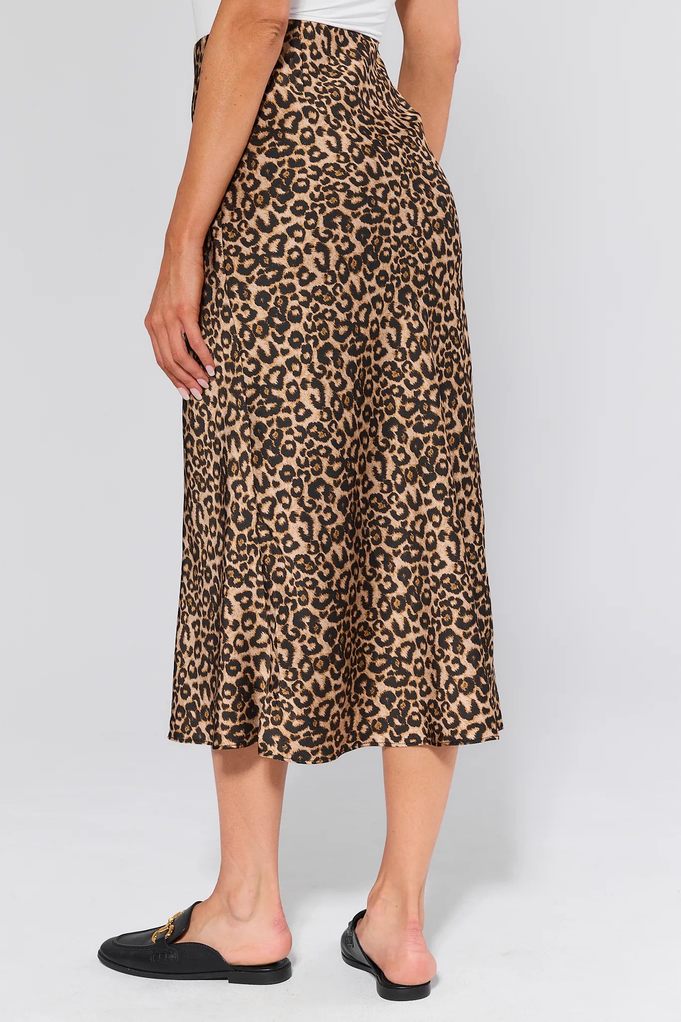 Person wearing a leopard print Gretchen Skirt on a plain background