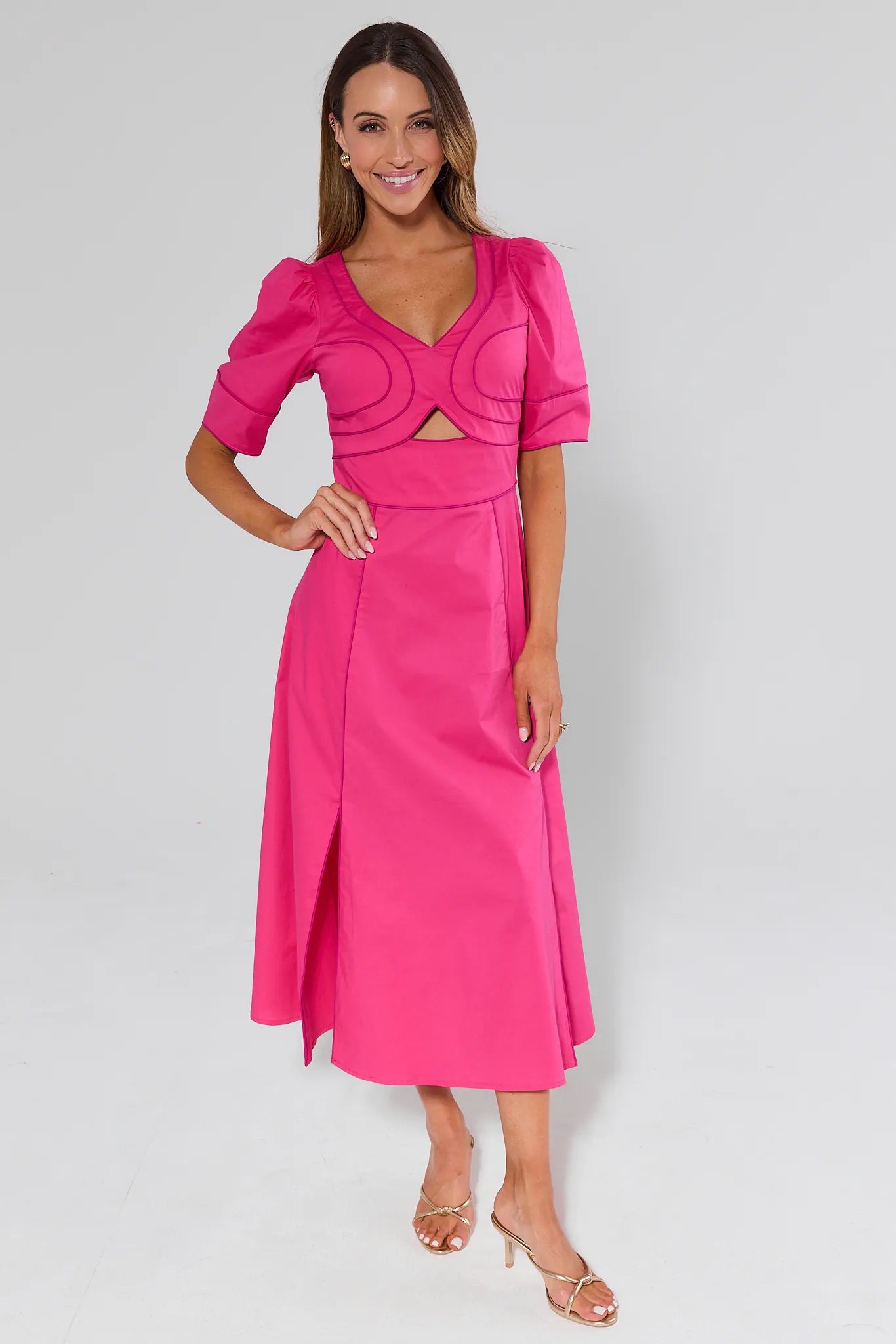 Woman wearing a Andrea Pink Maxi Dress with puff sleeves on a plain background