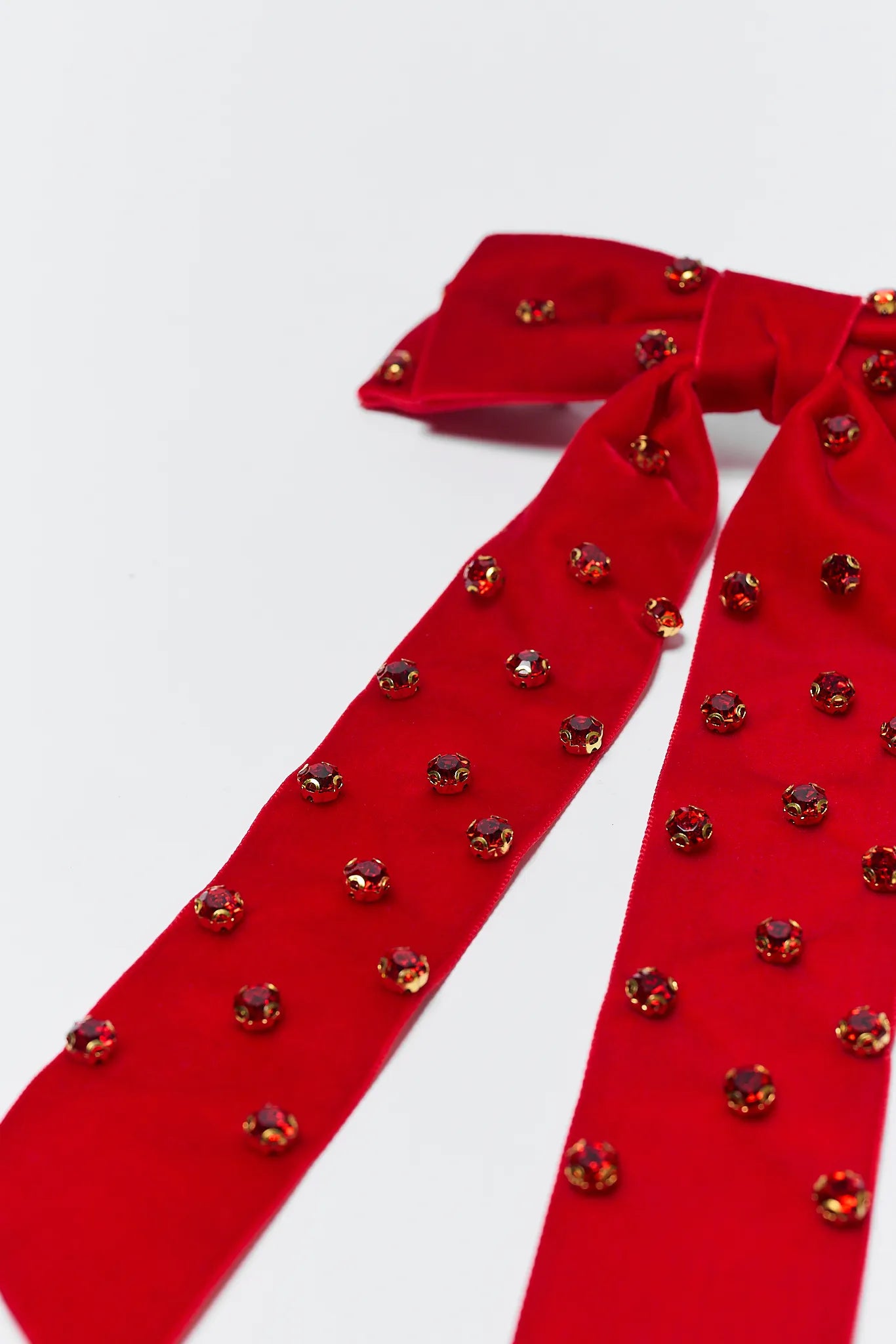 Red bow tie with decorative elements on a white background