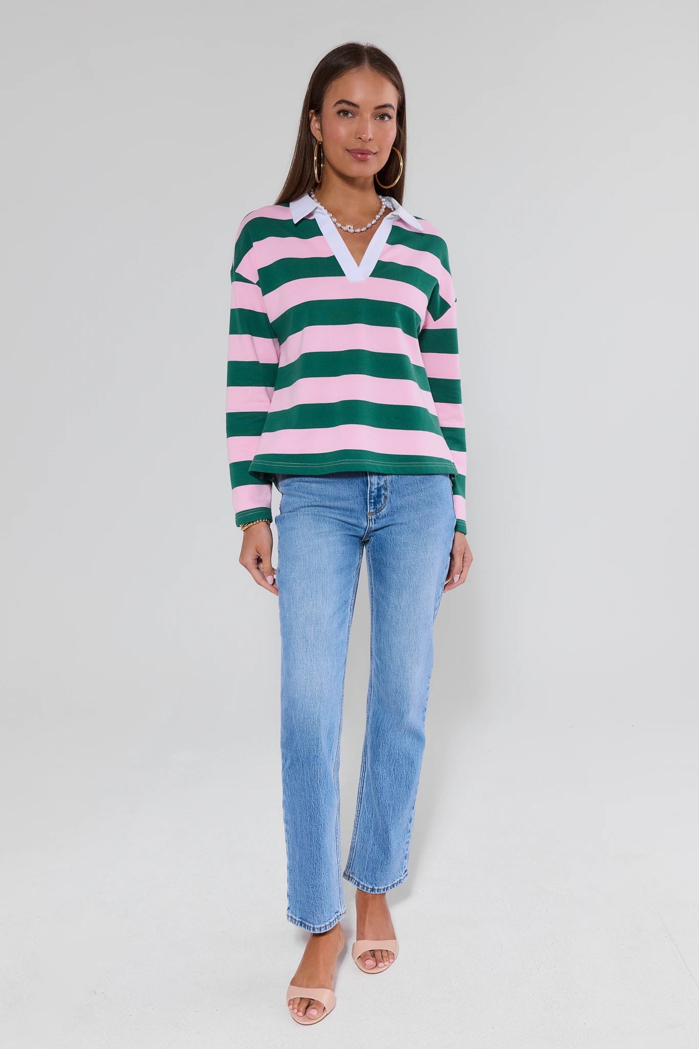 Woman wearing Lou Light Wash Straight Leg Jeans by Rolla's, paired with a striped rugby-style top and nude sandals, accessorized with hoop earrings and a beaded necklace.