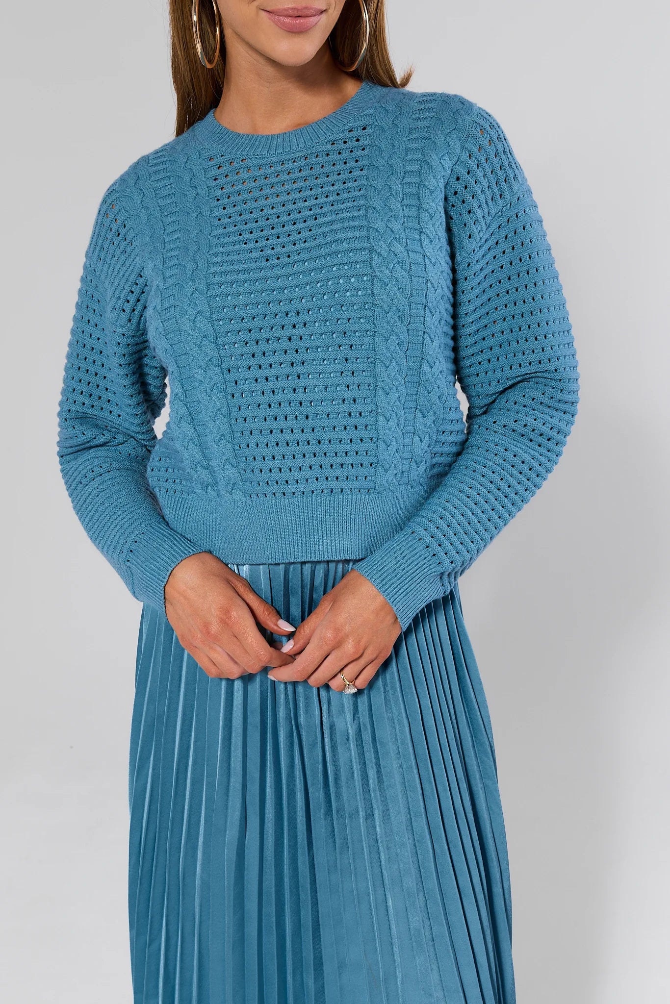 Woman wearing a Gabbie Dusty Blue Midi Dress on a white background