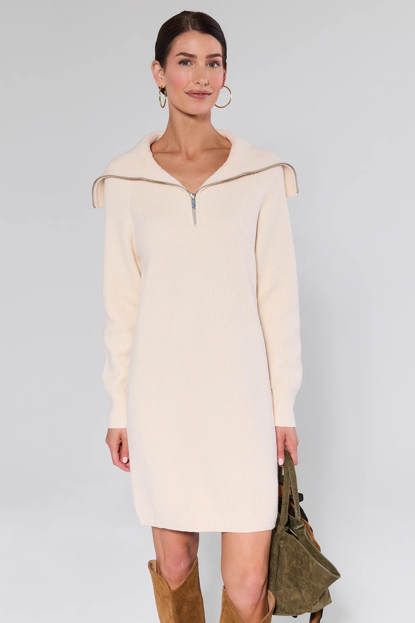 Woman wearing a Aubrey Ribbed Knit Sweater Dress with a zipper detail on a plain background