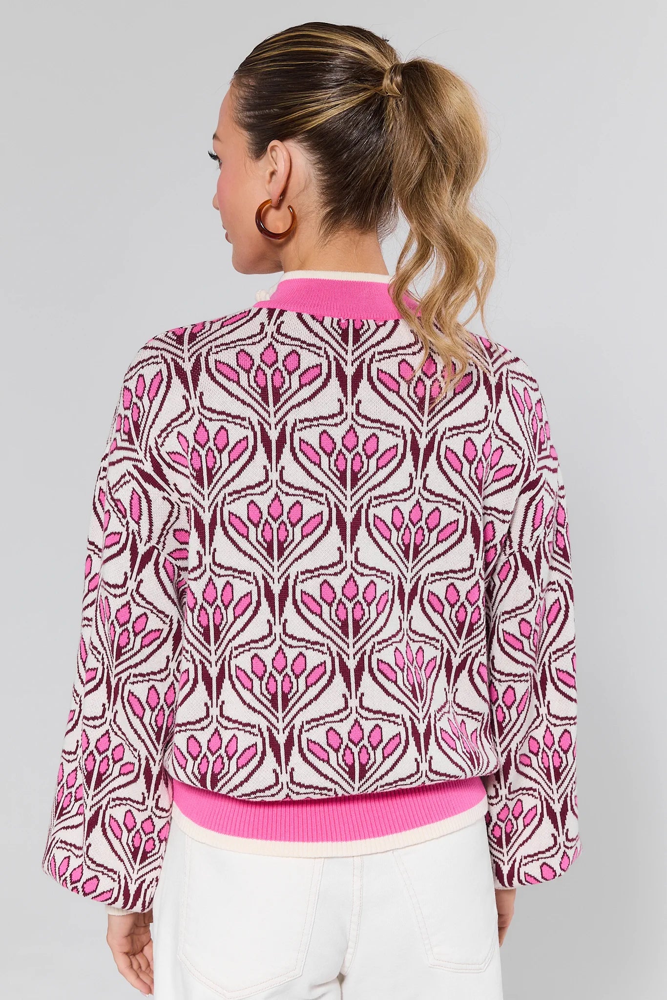 Woman wearing a Preston Pink Half Zip Sweater on a white background