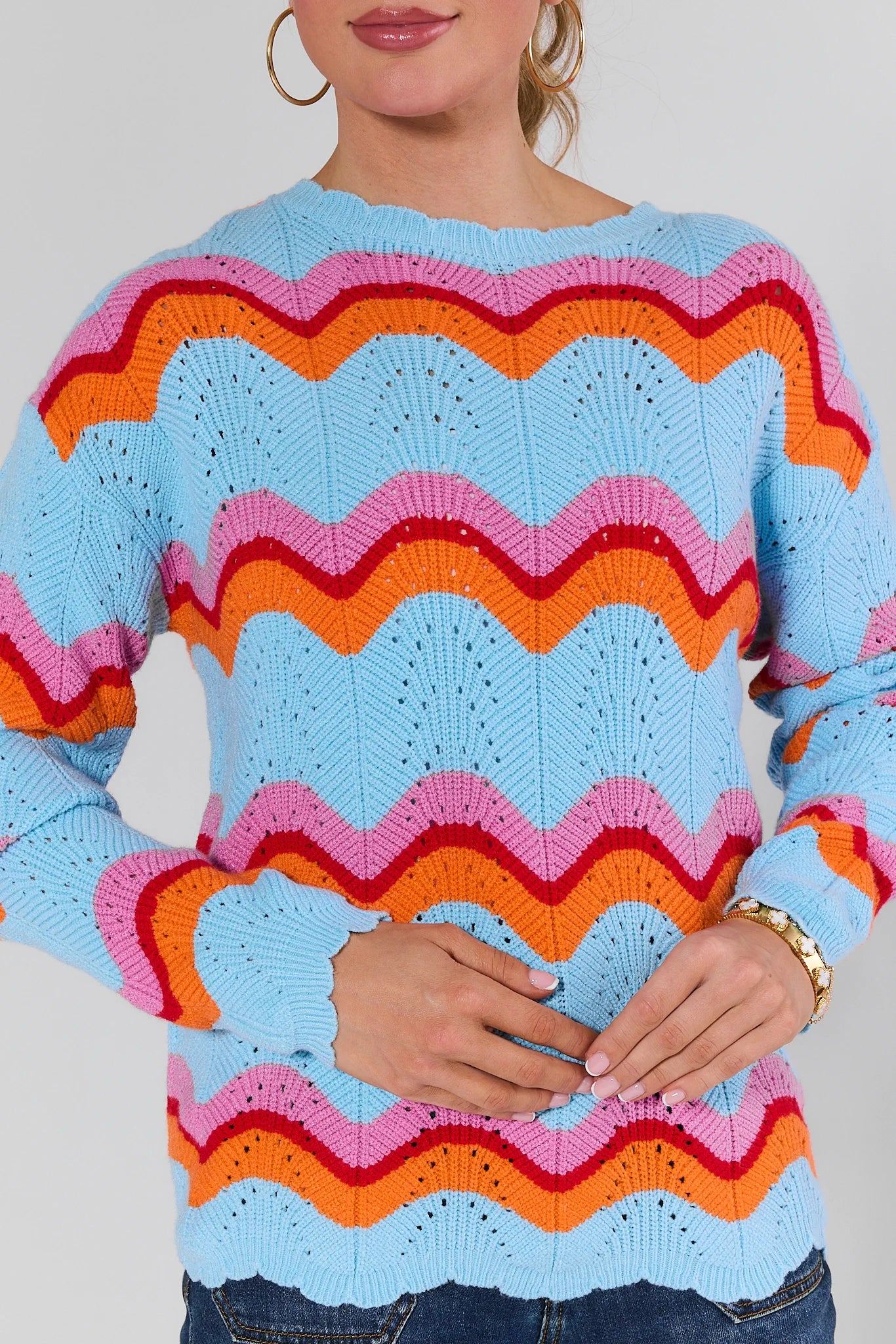 Person wearing a Alice Multi Striped Scallop Sweater with a plain background