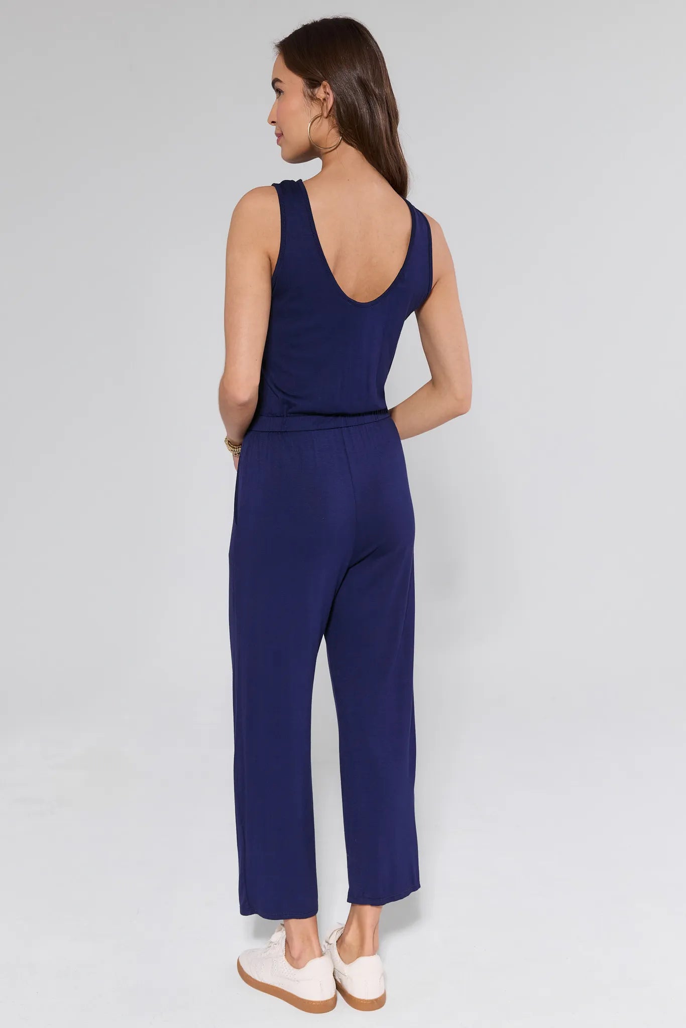 Woman wearing a blue jumpsuit on a white background