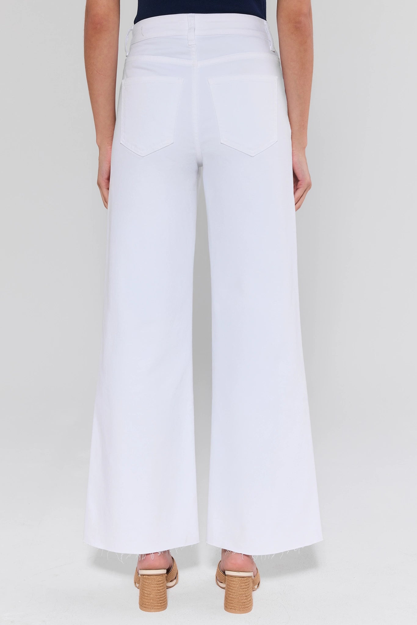White wide-leg pants worn by a person on a white background