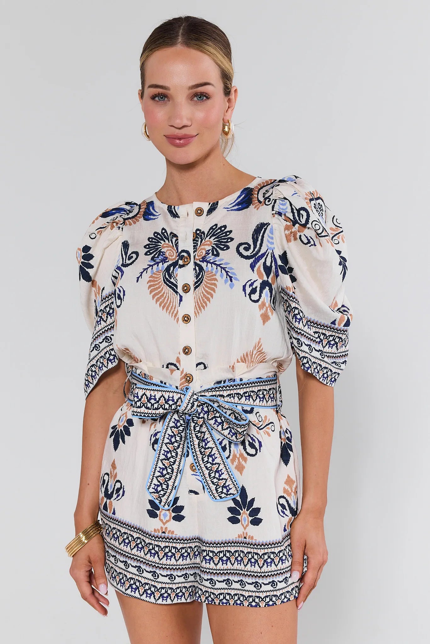 Woman wearing a patterned outfit with a white background