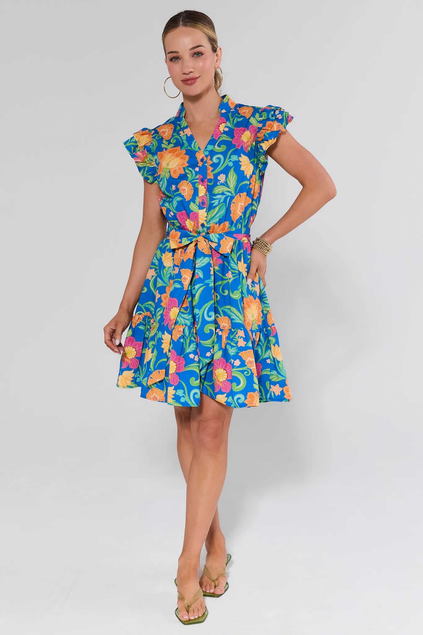 Woman wearing a colorful floral dress on a white background