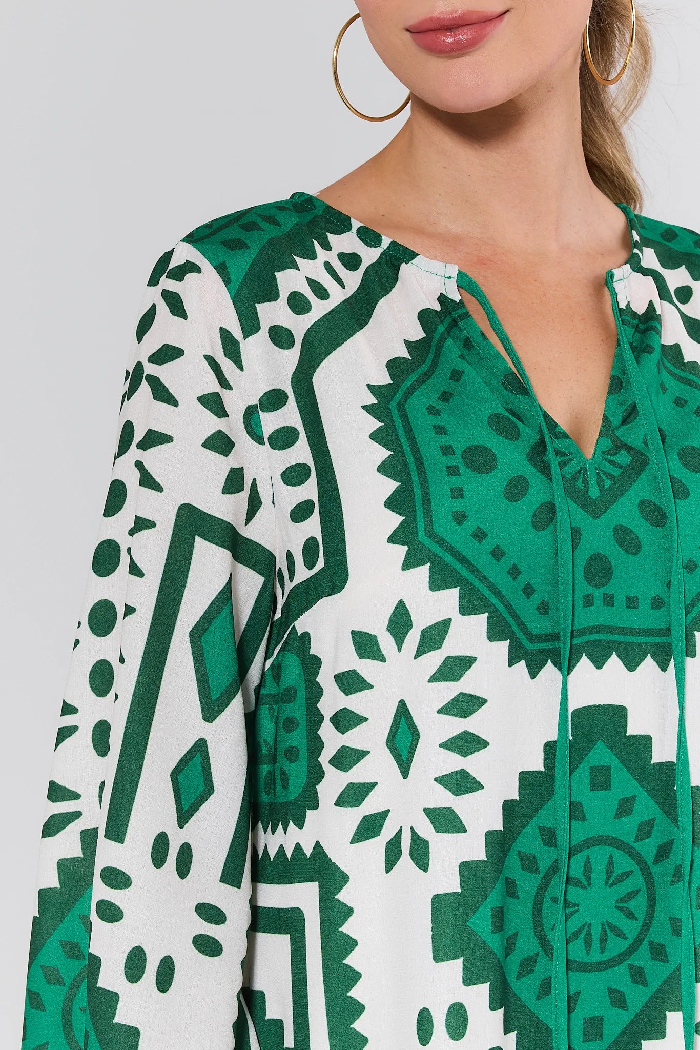 Green and white patterned dress with a close-up on a neutral background