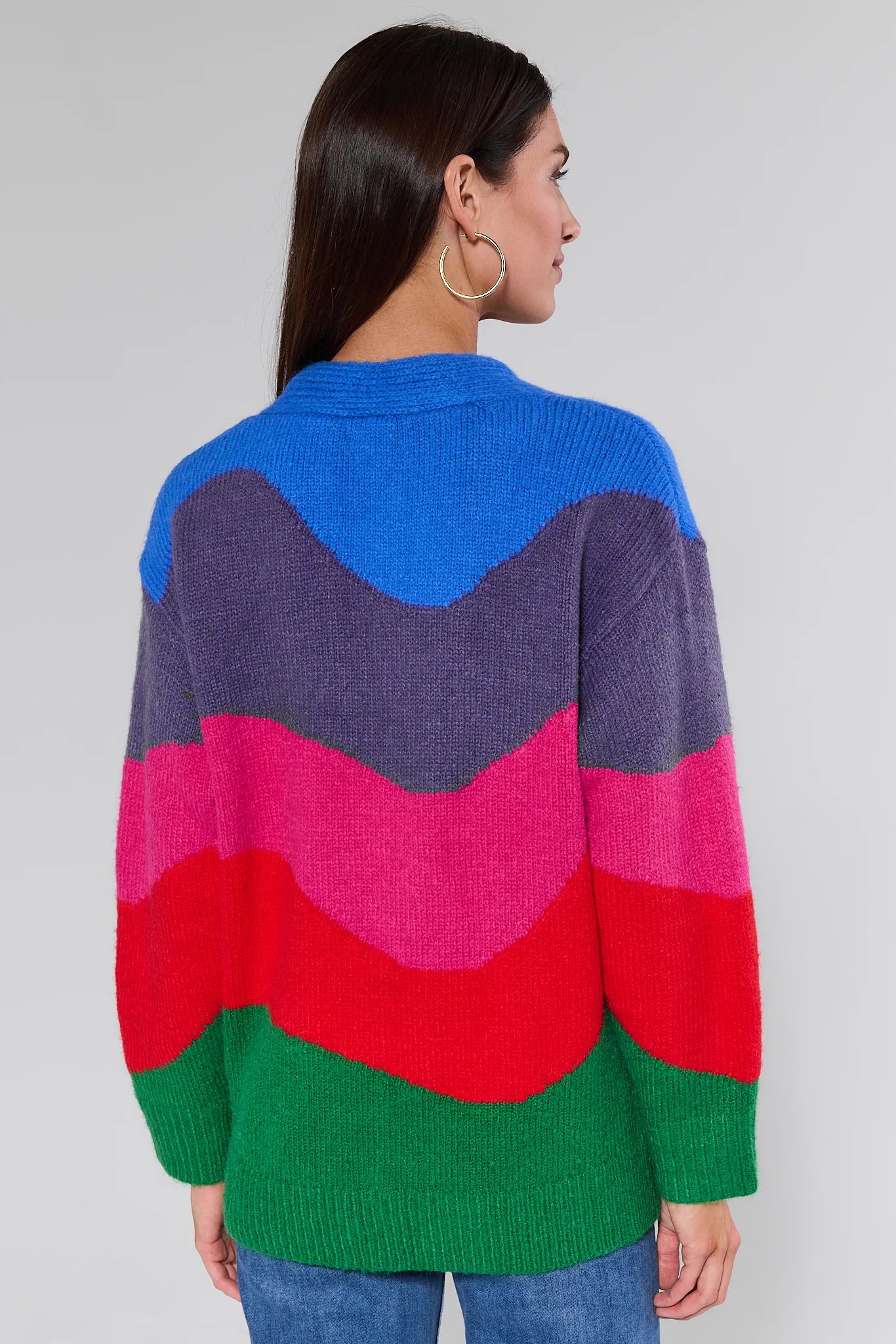 Woman wearing a Brandy Multi Striped Knit Cardigan against a plain background