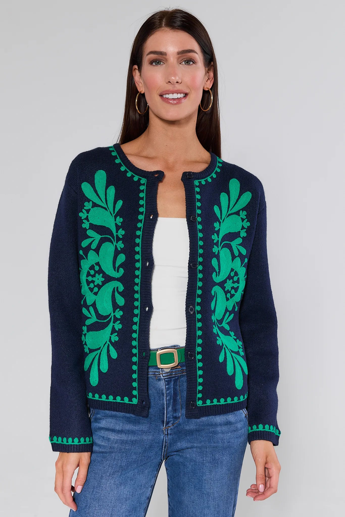 Woman wearing a Myra Navy Embroidered Cardigan on a plain background