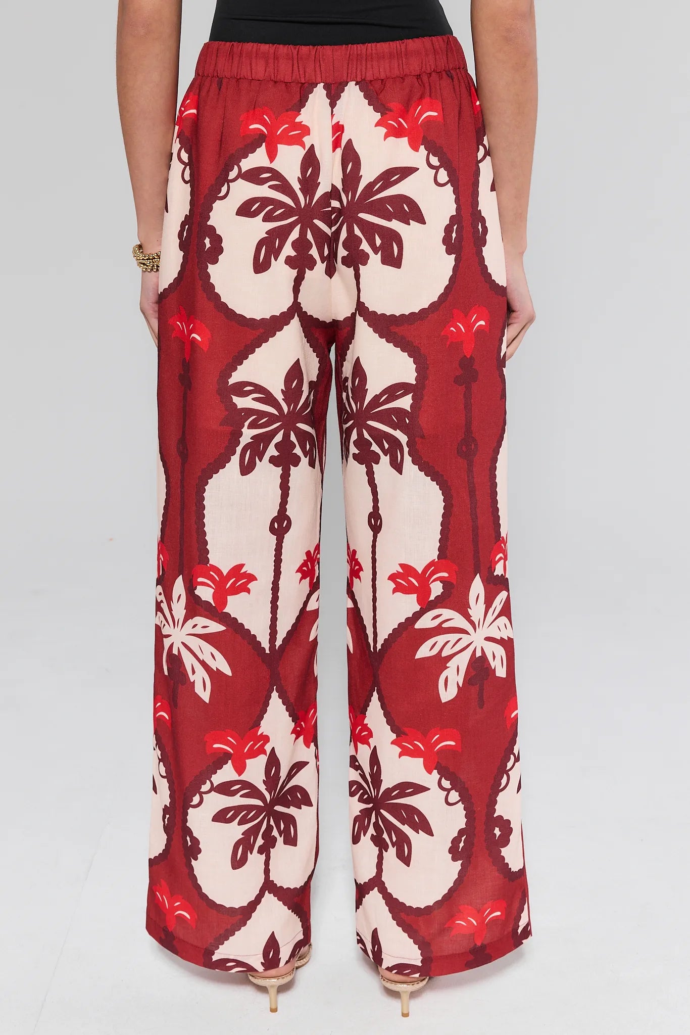 Celine Maroon Printed Pants worn by a person on a plain background