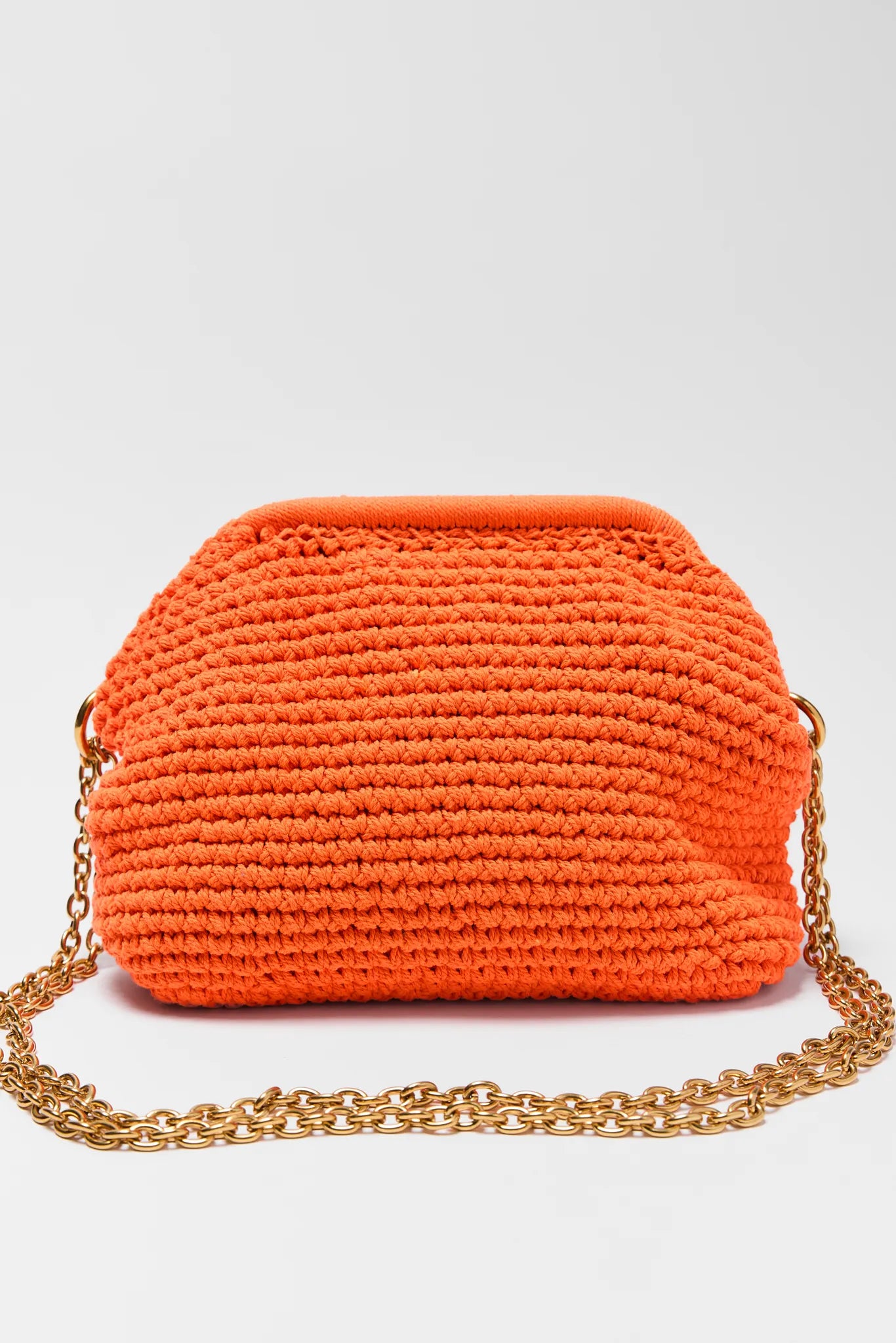Gabbie Orange Crochet Shoulder Bag with a gold chain on a white background