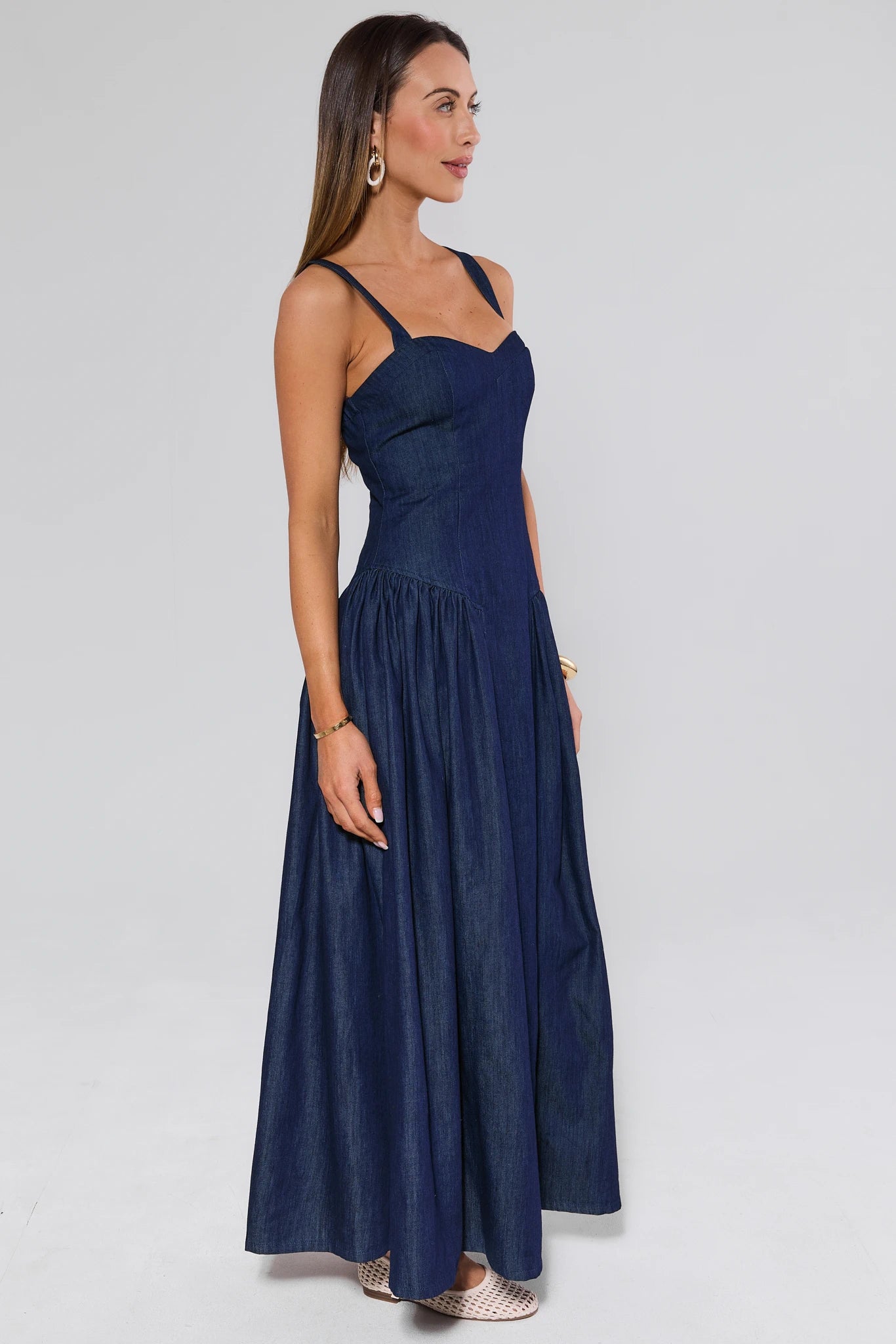 Woman wearing a navy blue dress on a white background