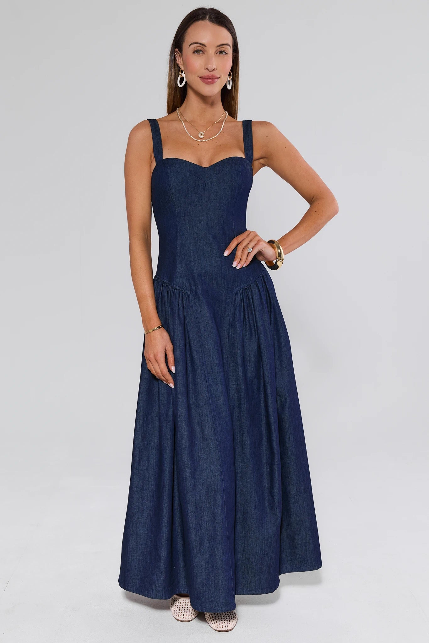 Woman wearing a navy blue dress against a white background