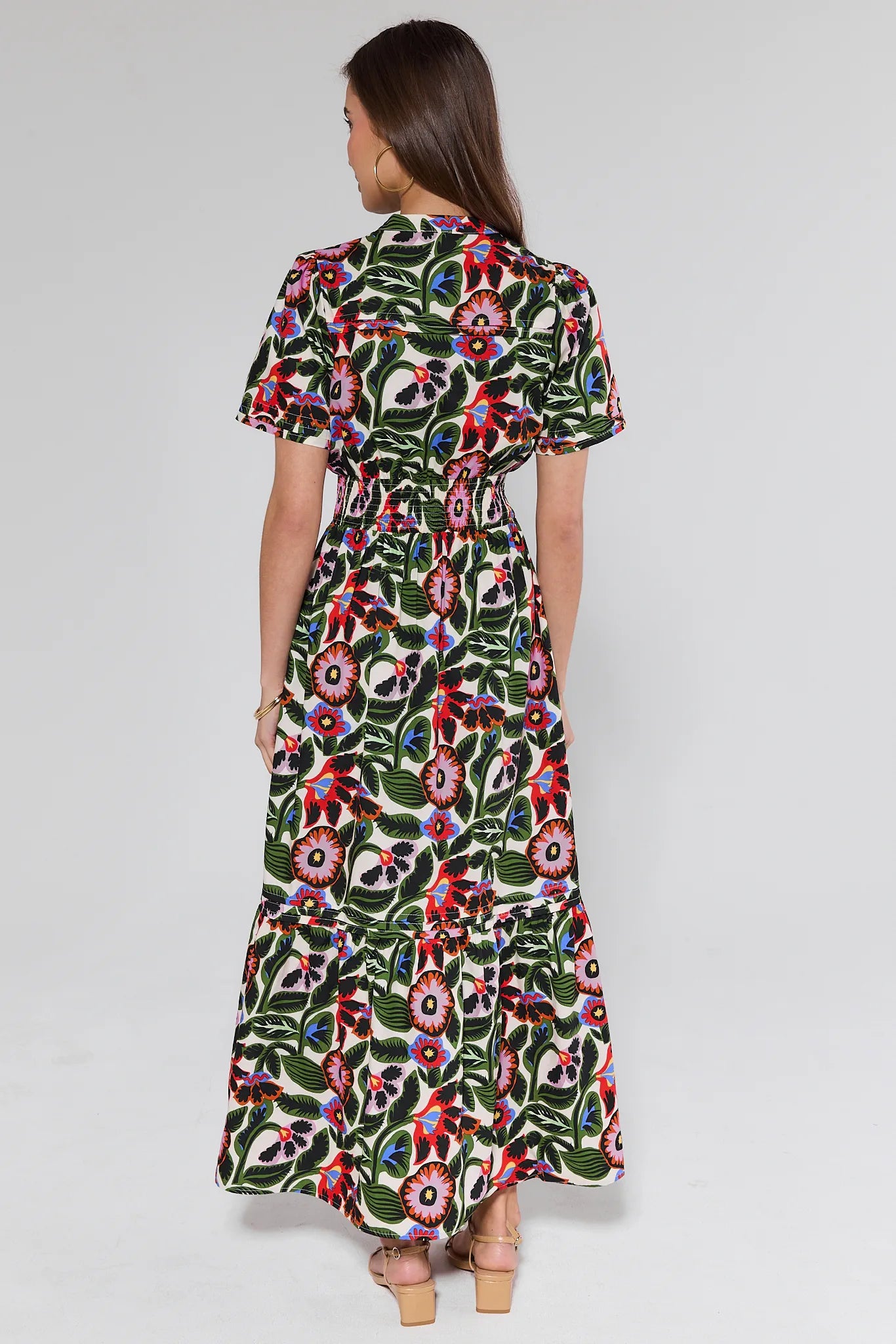 person wearing a floral dress on white background