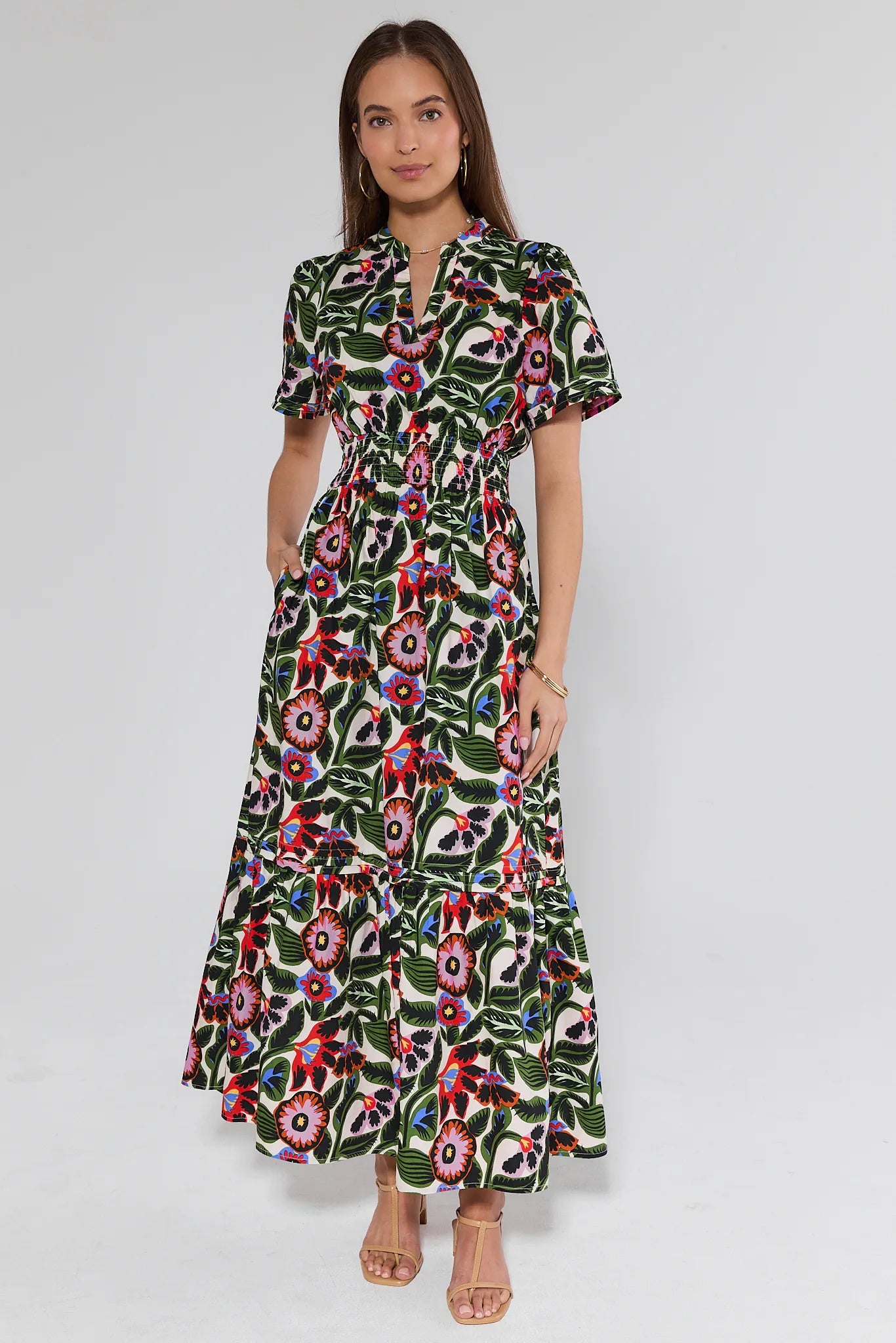 woman wearing a floral dress and heels on white background