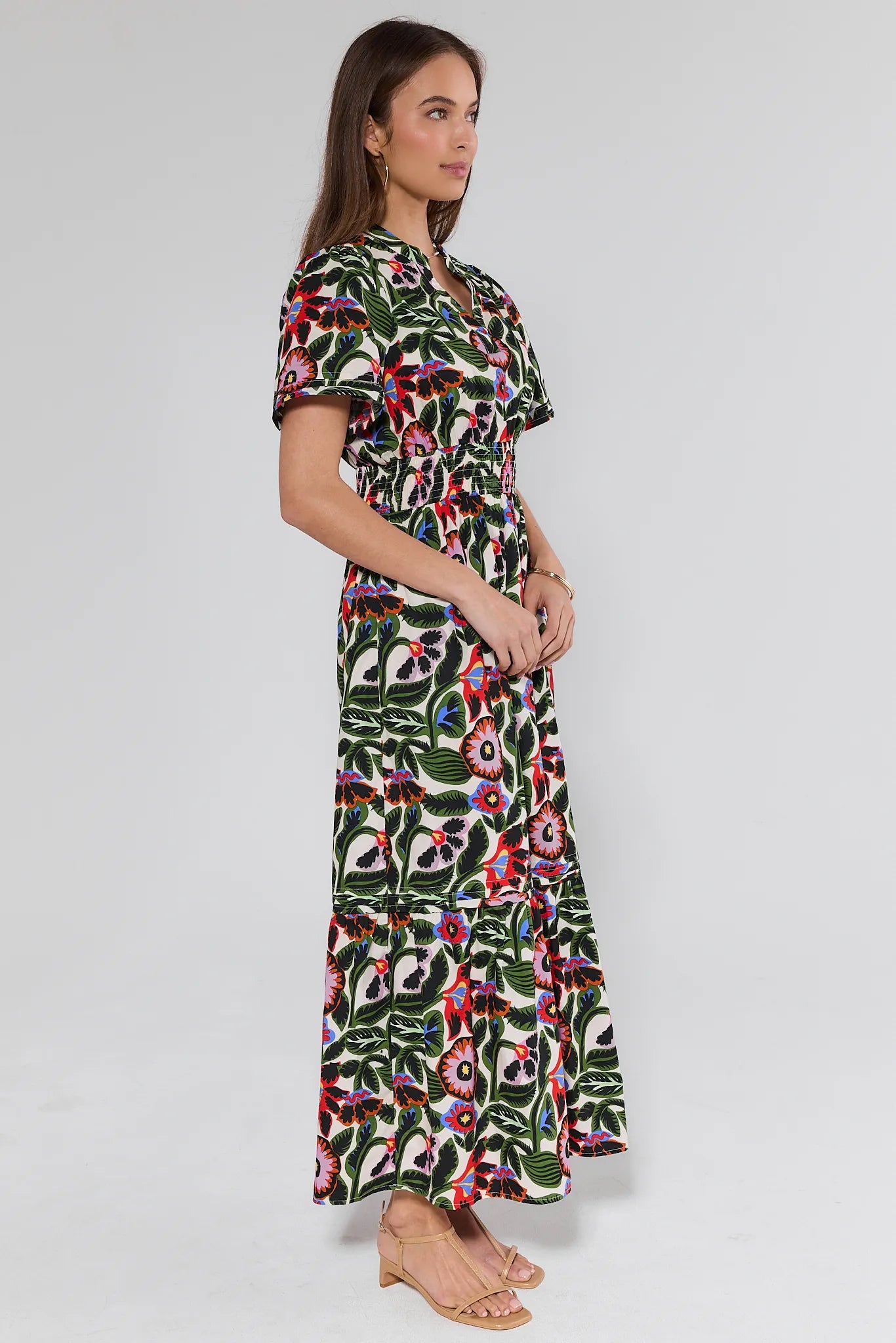 woman wearing a floral midi dress on white background
