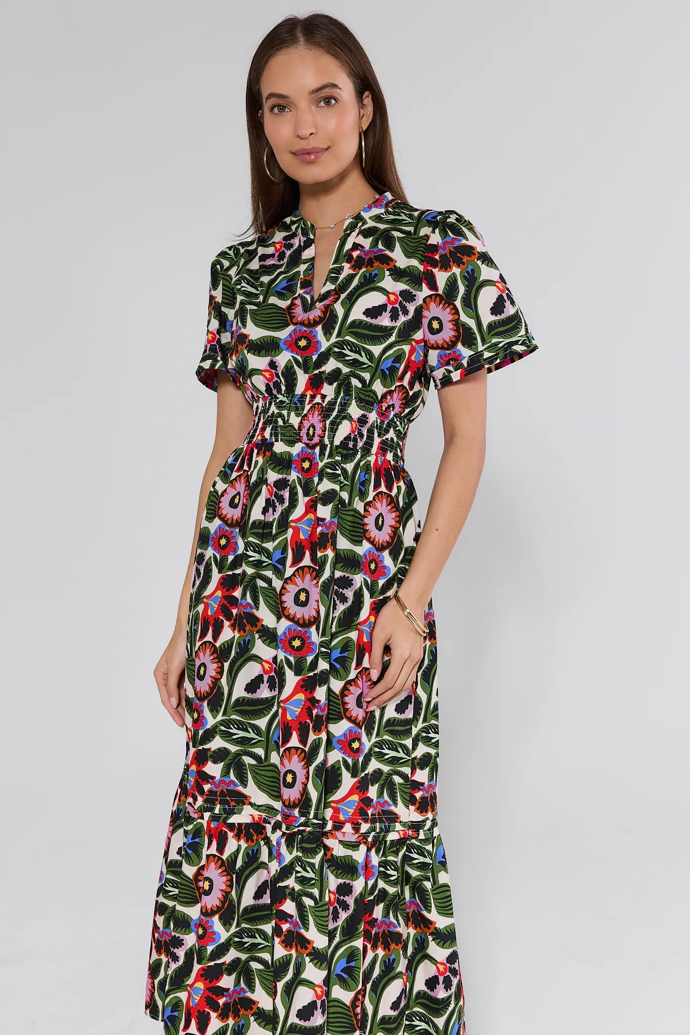 woman wearing a floral midi dress on white background
