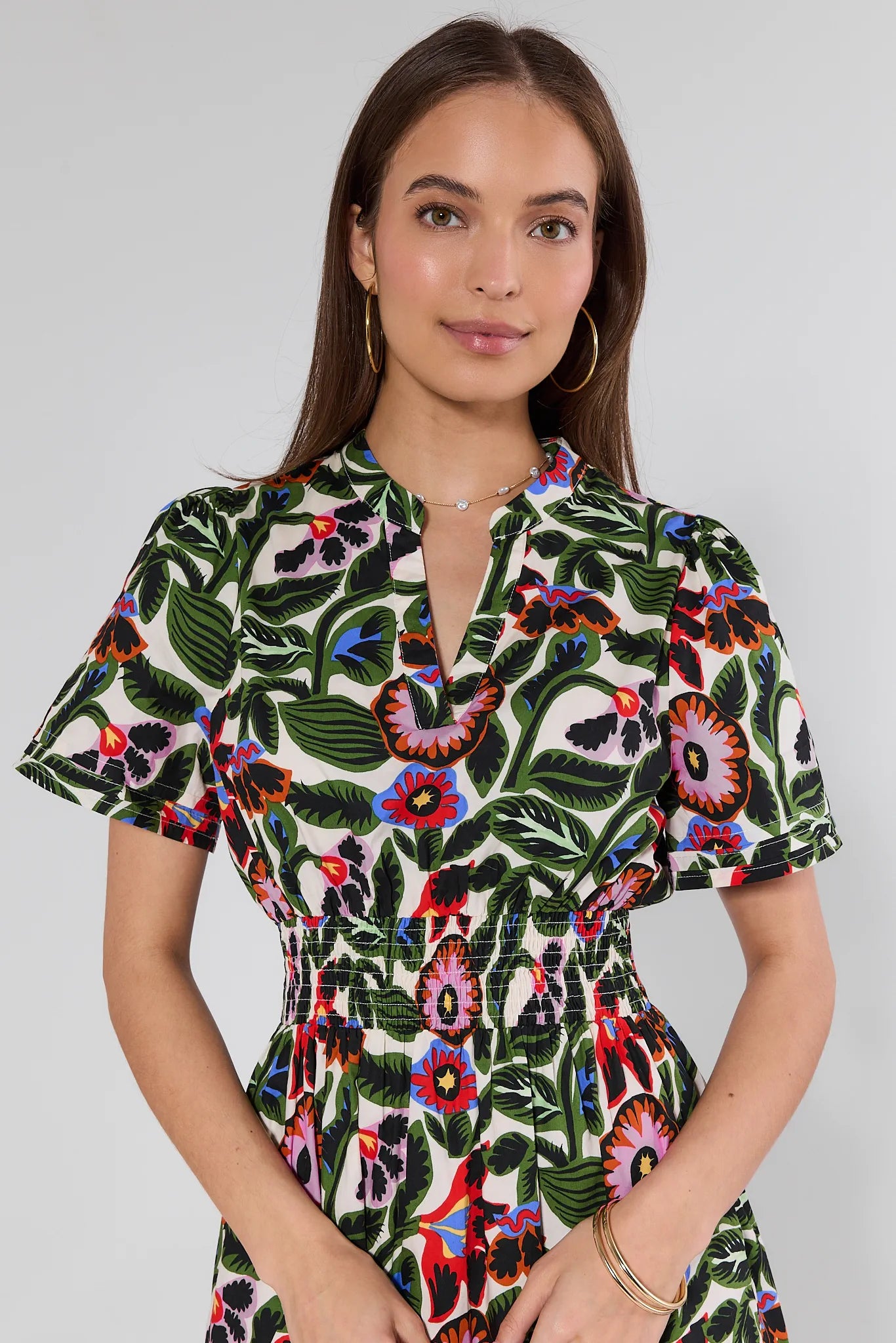 woman wearing a floral dress on white background