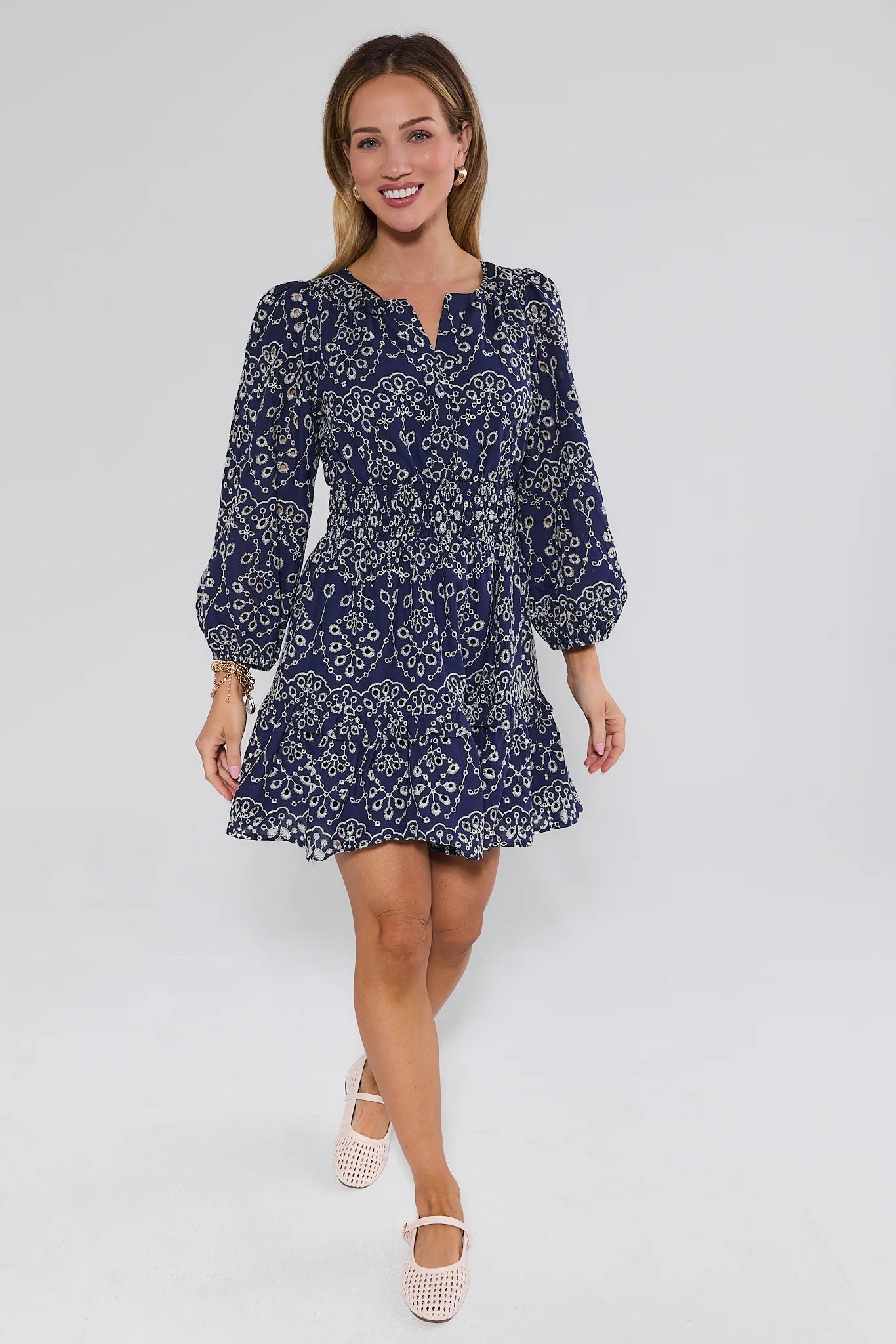 Woman wearing a blue floral dress on a white background